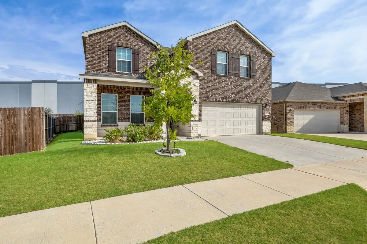 Two-story exterior with brick and stone accents