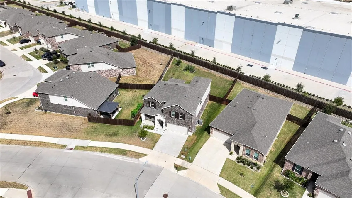 Aerial perspective showcasing multiple residential properties with gray shingle roofs