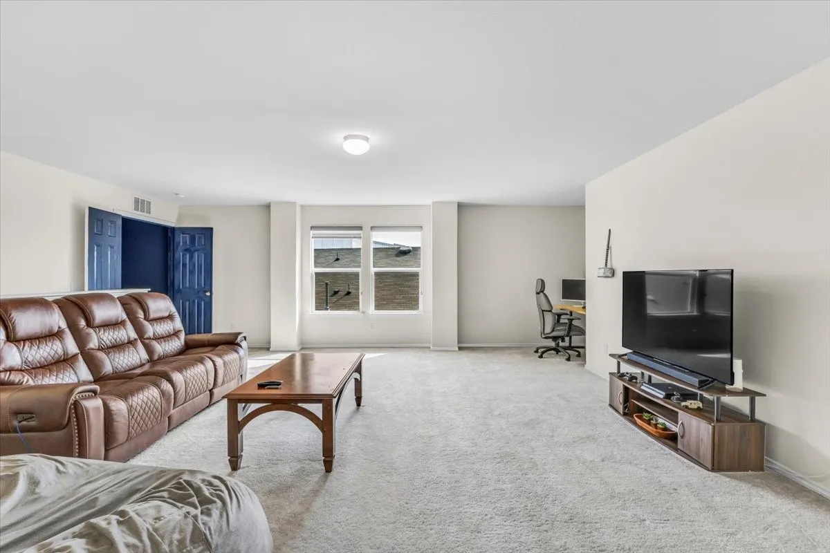 Bright interior with light-toned wall finishes, recessed lighting, and dual windows