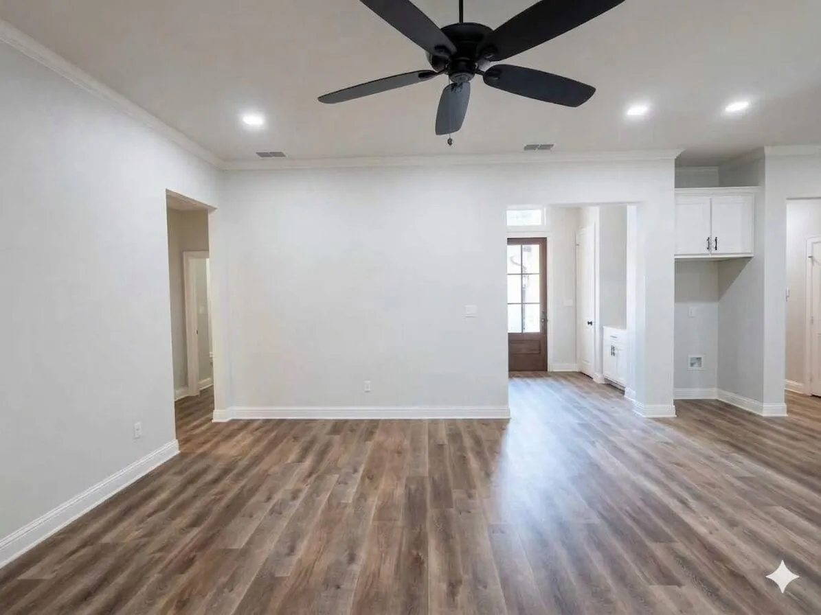 Wood-finish flooring throughout, recessed ceiling lighting, a dark-toned ceiling fan, crown molding, and built-in cabinetry