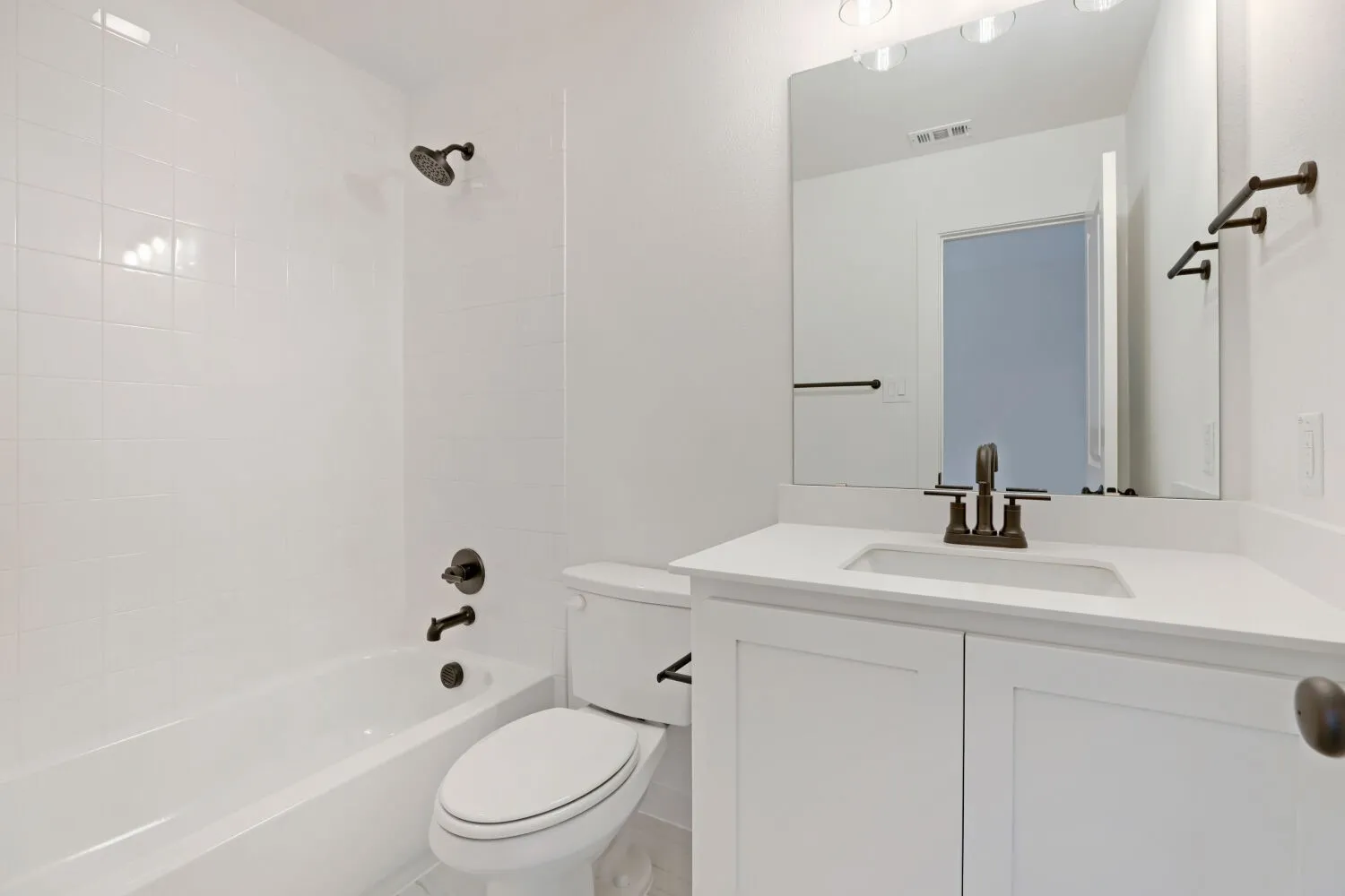 White subway tile shower surround with a built-in tub