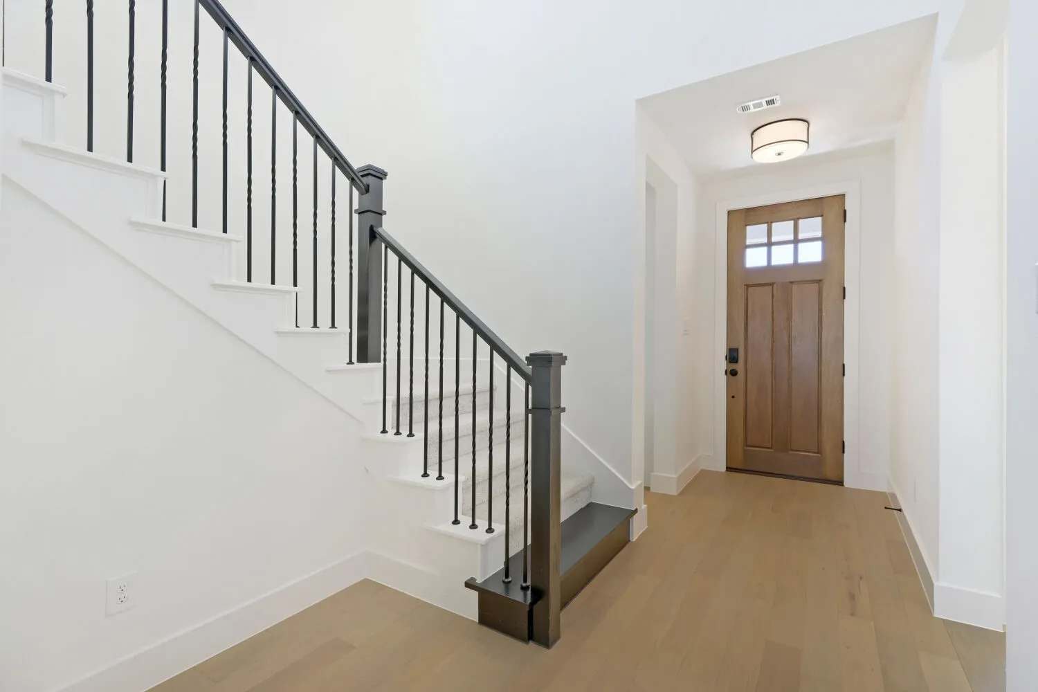 Light wood-finish flooring extending from the entryway