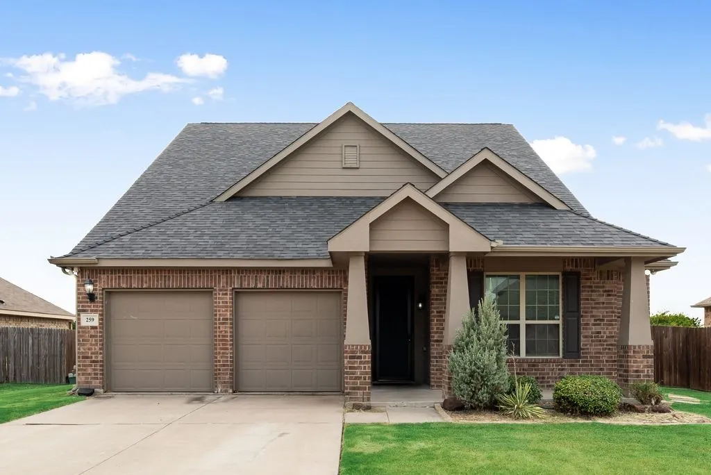 Brick and siding exterior with a gabled roofline and multiple roof peaks