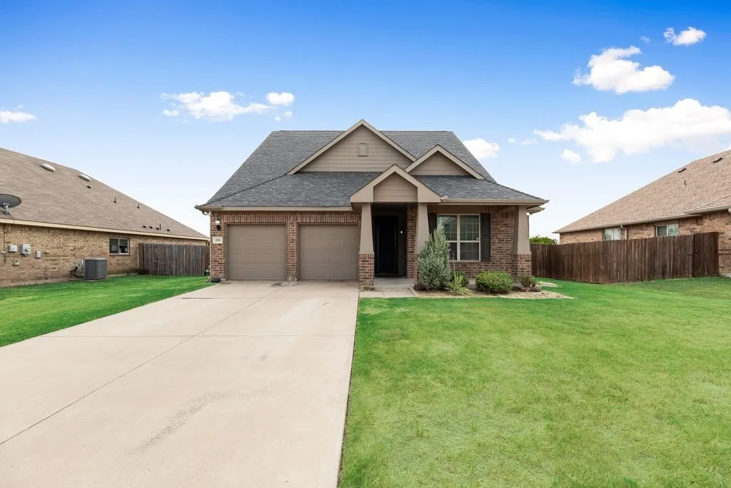 Brick exterior with architectural gable detailing and professional landscaping