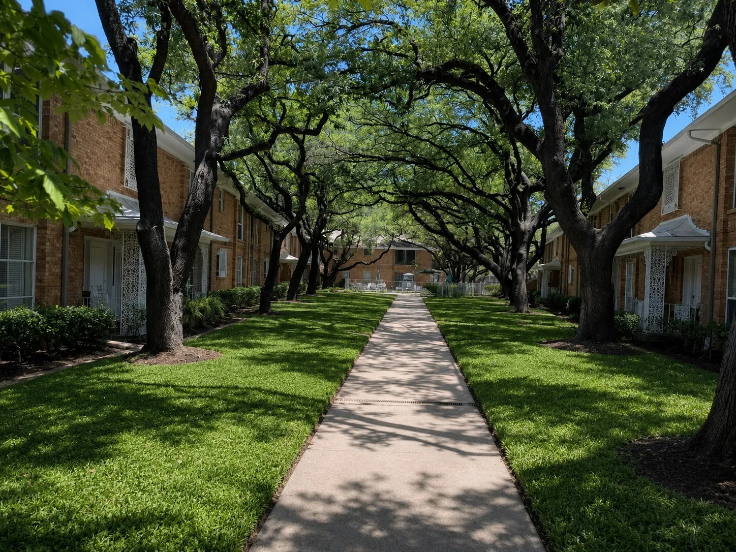 SERENE, PARK-LIKE SETTING: Beautiful mature trees, lush greenery and shaded walkways surround the residences, creating a peaceful retreat that feels tucked away from the city.