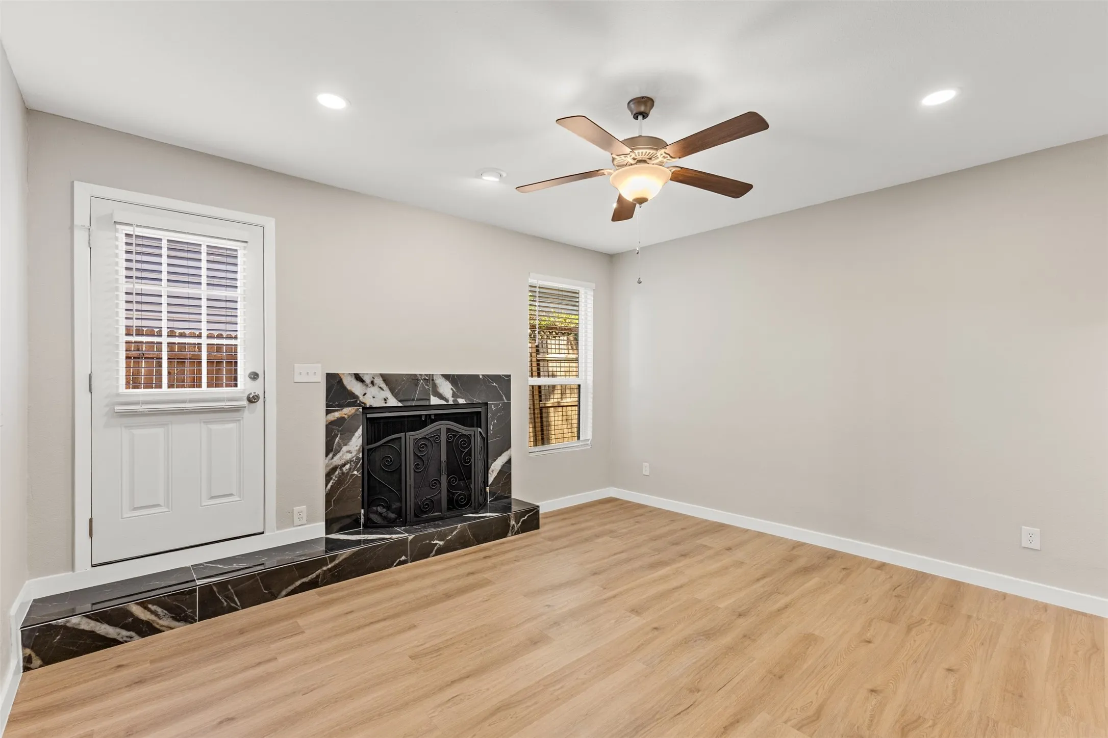 Wood-finish flooring, recessed lighting, and a ceiling fan with light fixture