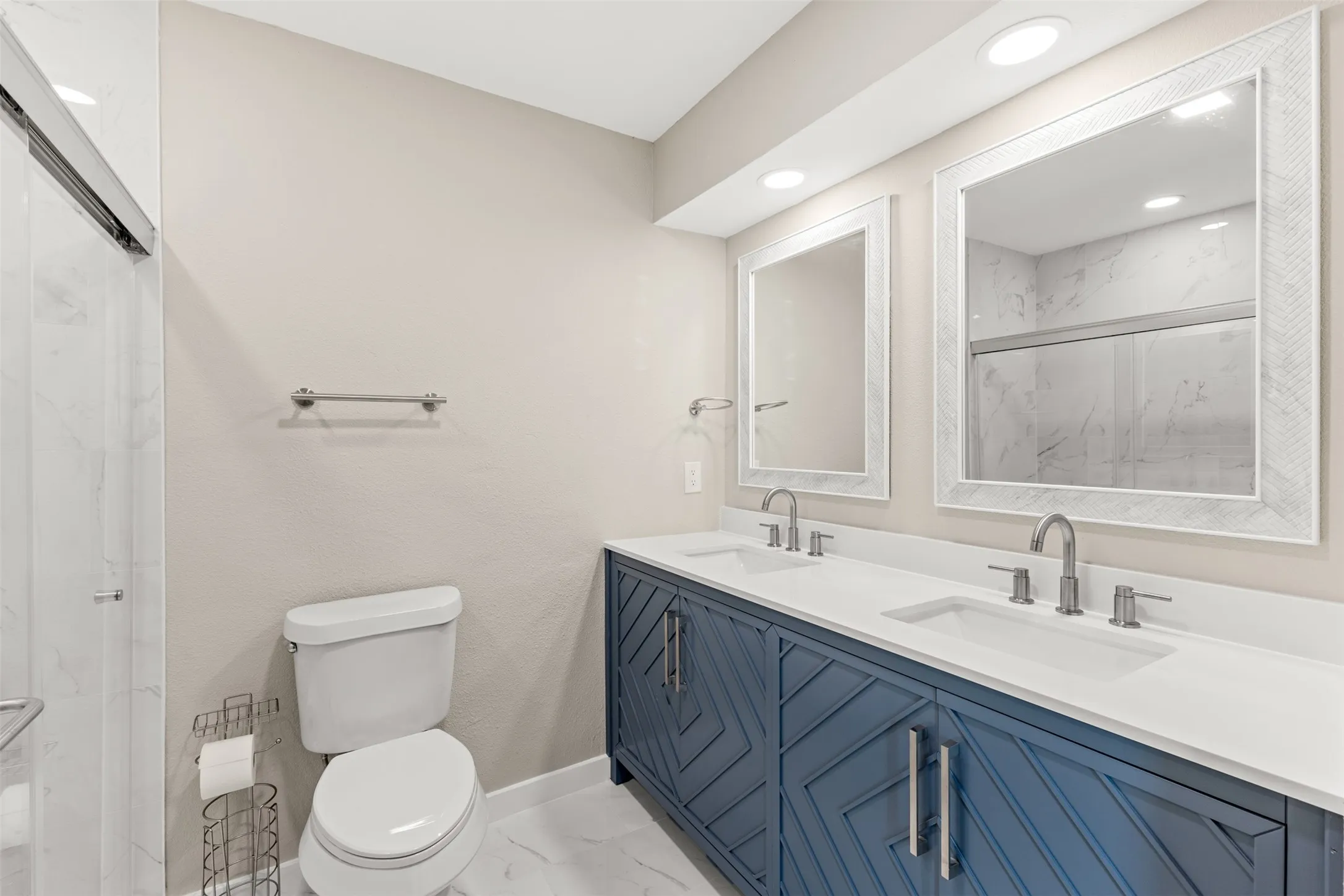 Dual vanity with white countertops, integrated sinks, and brushed nickel fixtures
