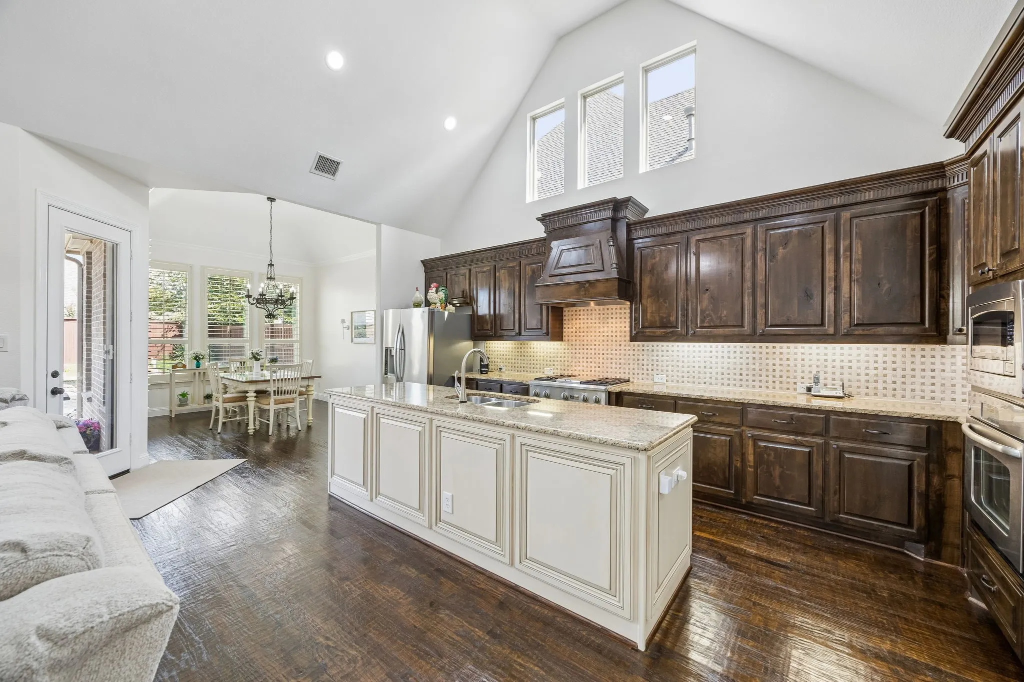 Hand scraped hard wood floors, island, lots of cabinets and counter space.  Open floor plan.