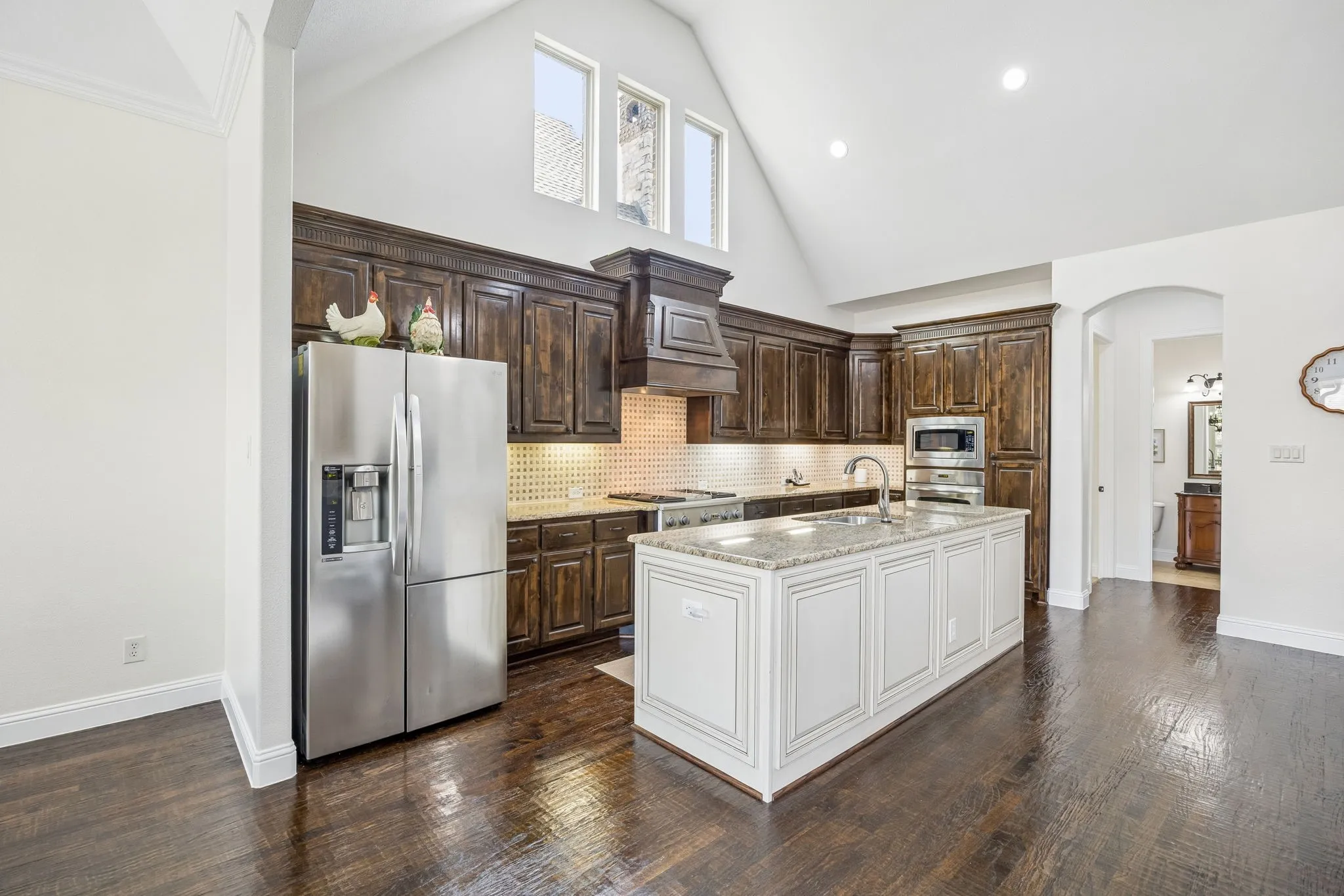 Spacious kitchen with lots of cabinets, counters and an island.
