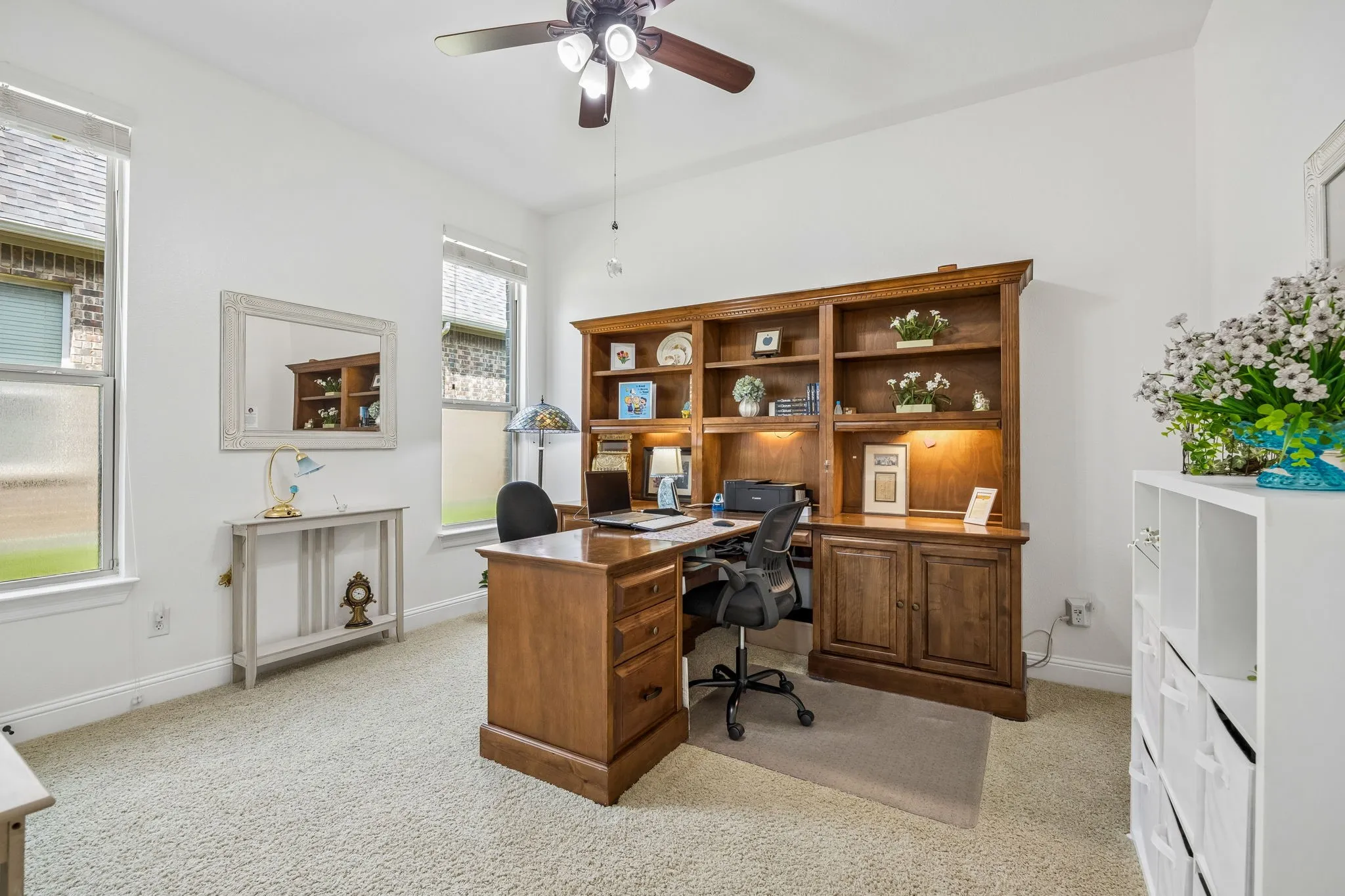One of the bedrooms which is being used as an office. The custom built furniture is included.  Ceiling fan, carpet and a walk in closet.