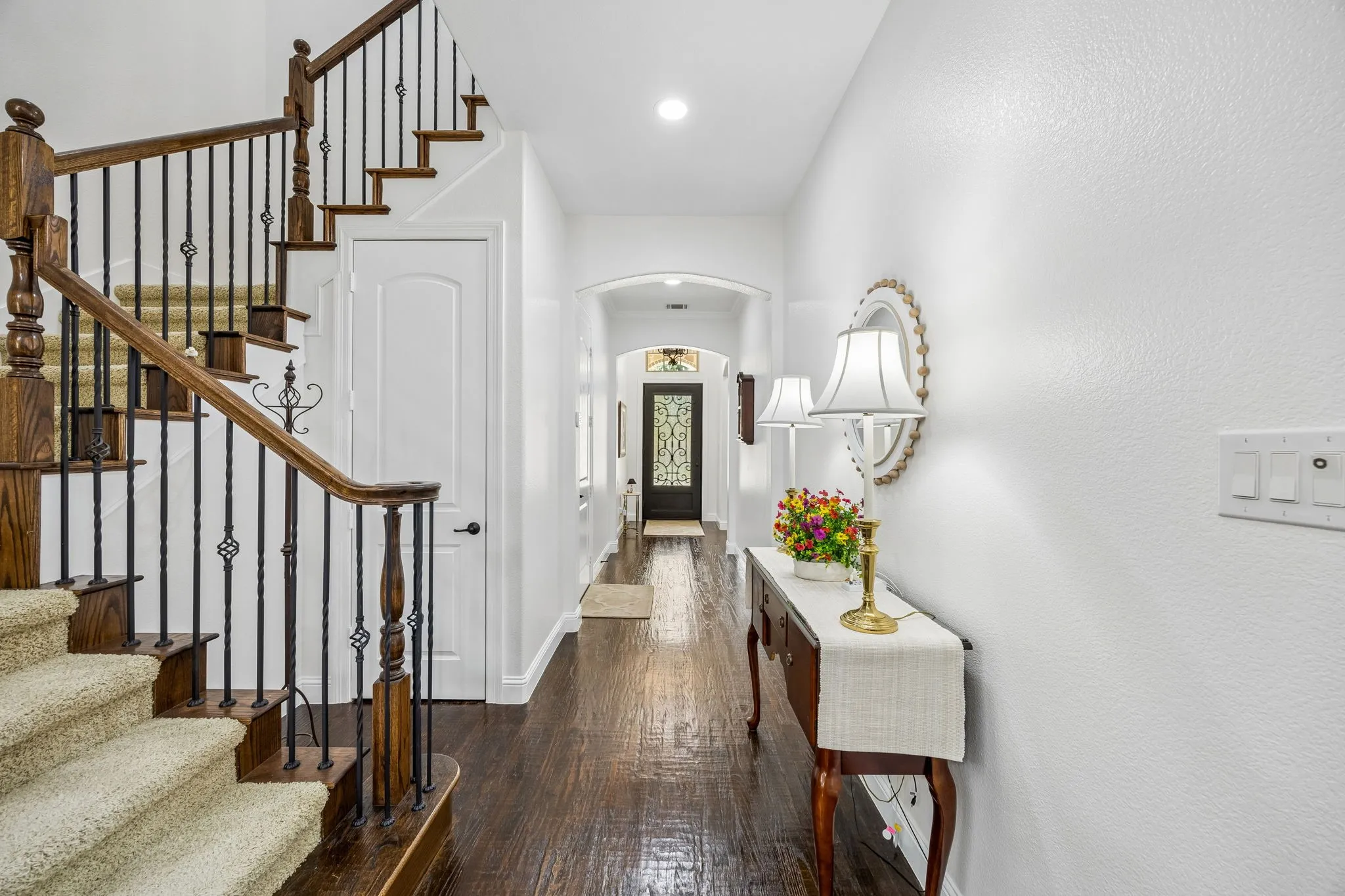 Hand scraped hard wood floors in the entry.  Wrought iron spindles.