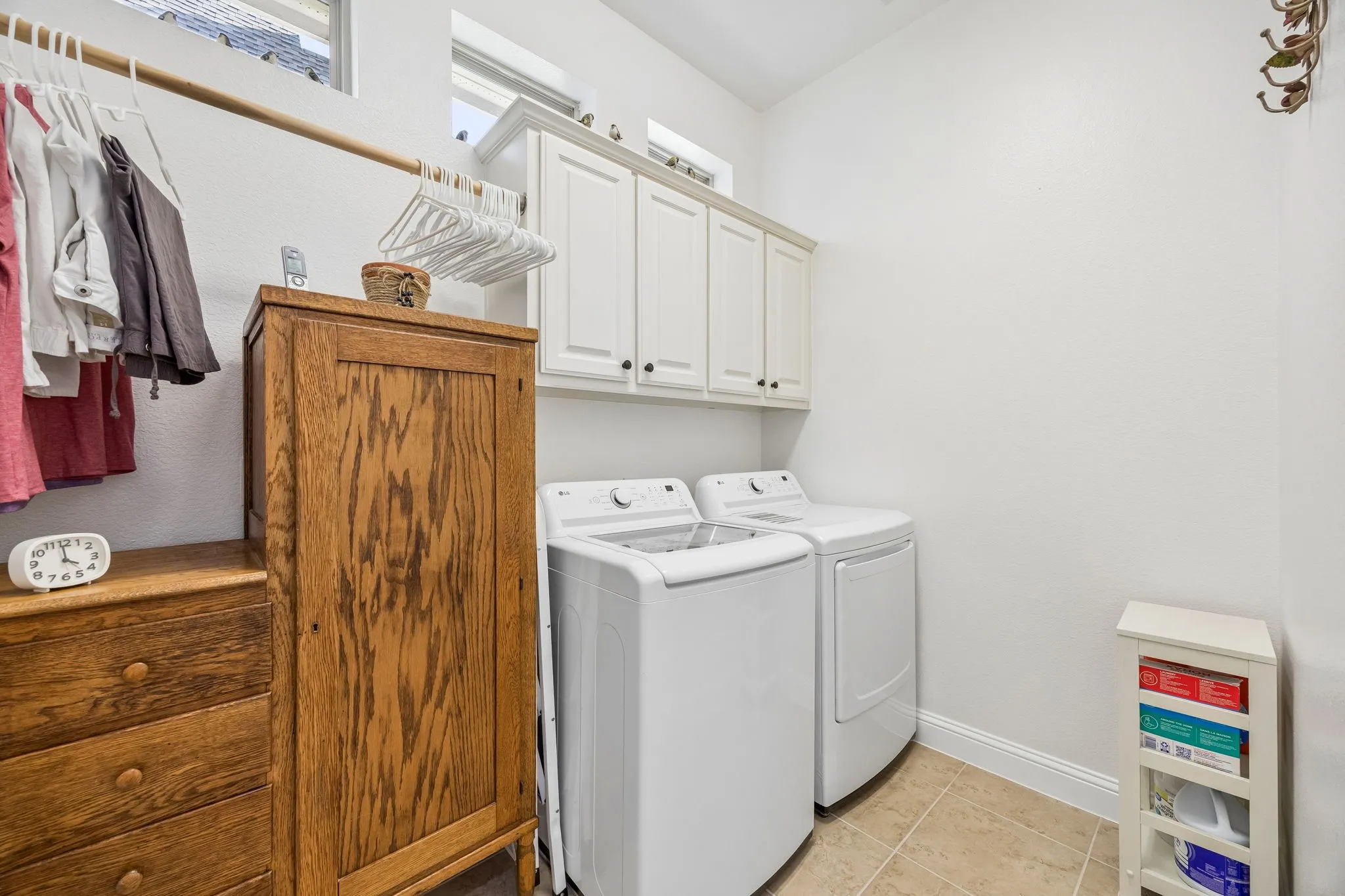 Laundry room with rod for hanging clothes.  Space for a second refrigerator or freezer too.