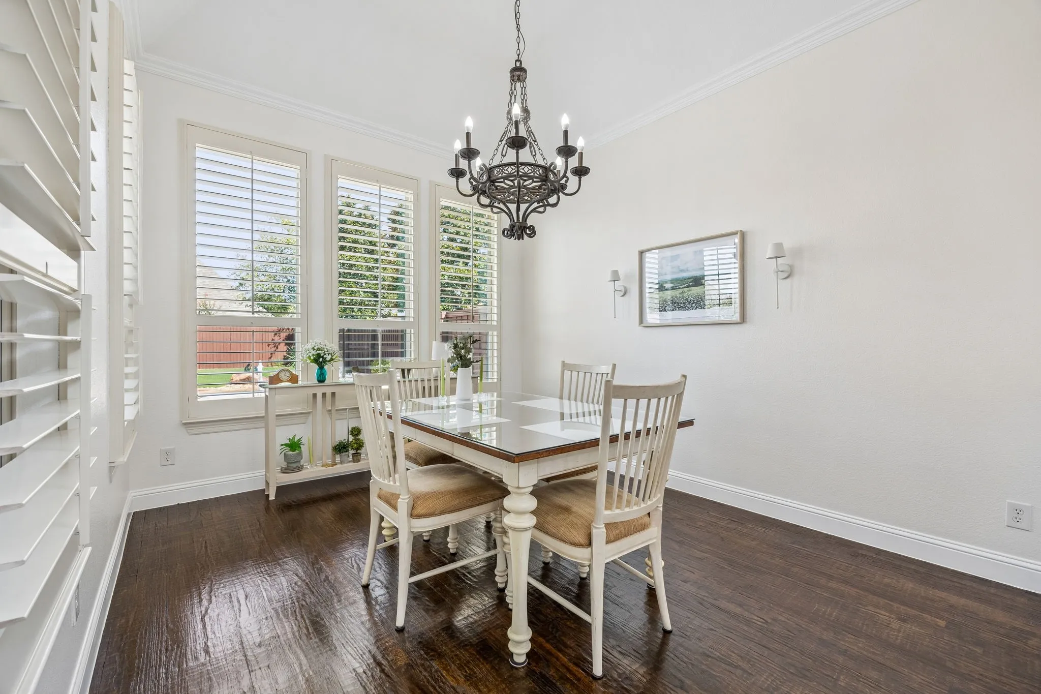 Breakfast area with shutters.  Windows look out to the pool and the landscaped back yard.