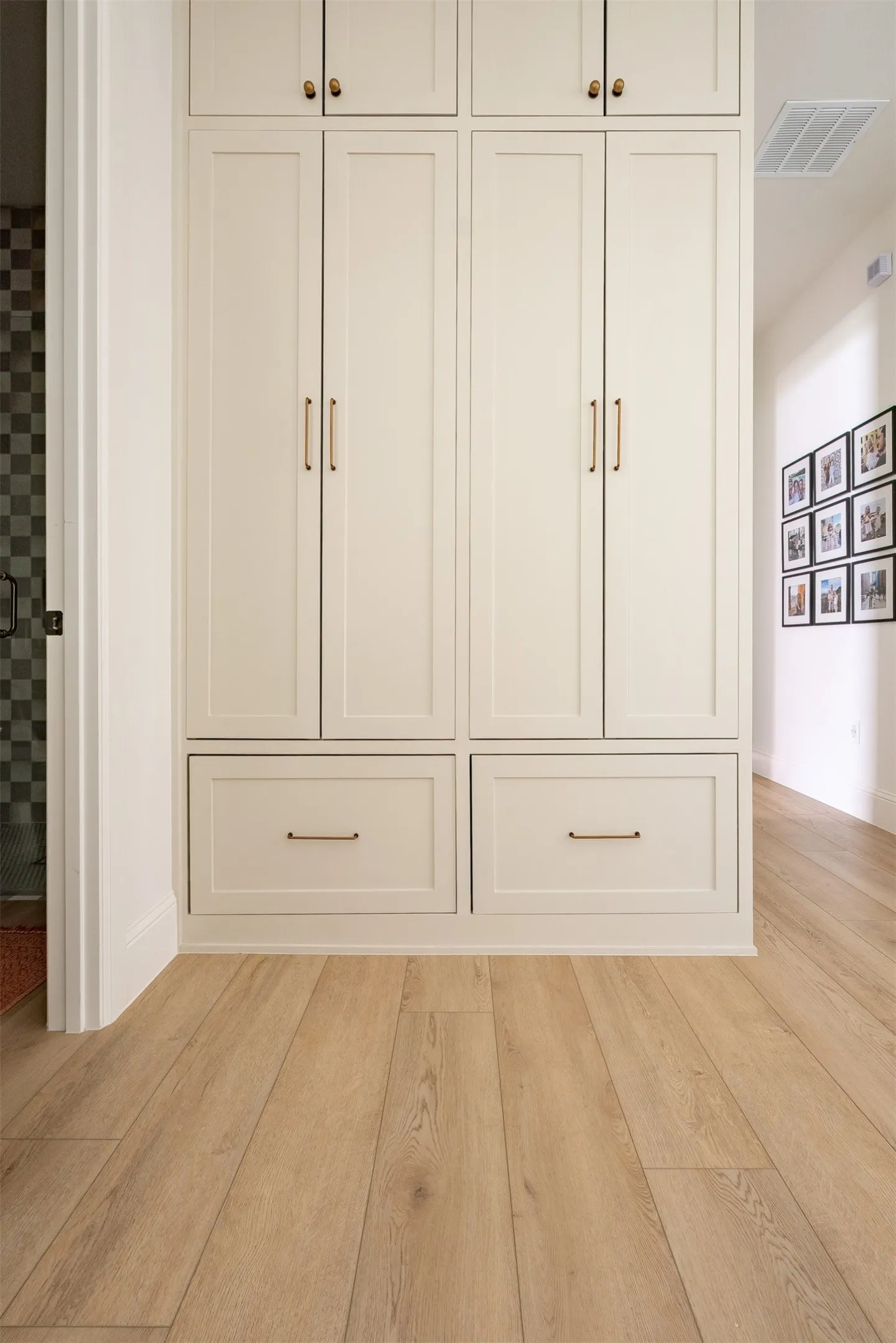 Built-in cabinetry with ample storage, featuring panel doors and drawer fronts