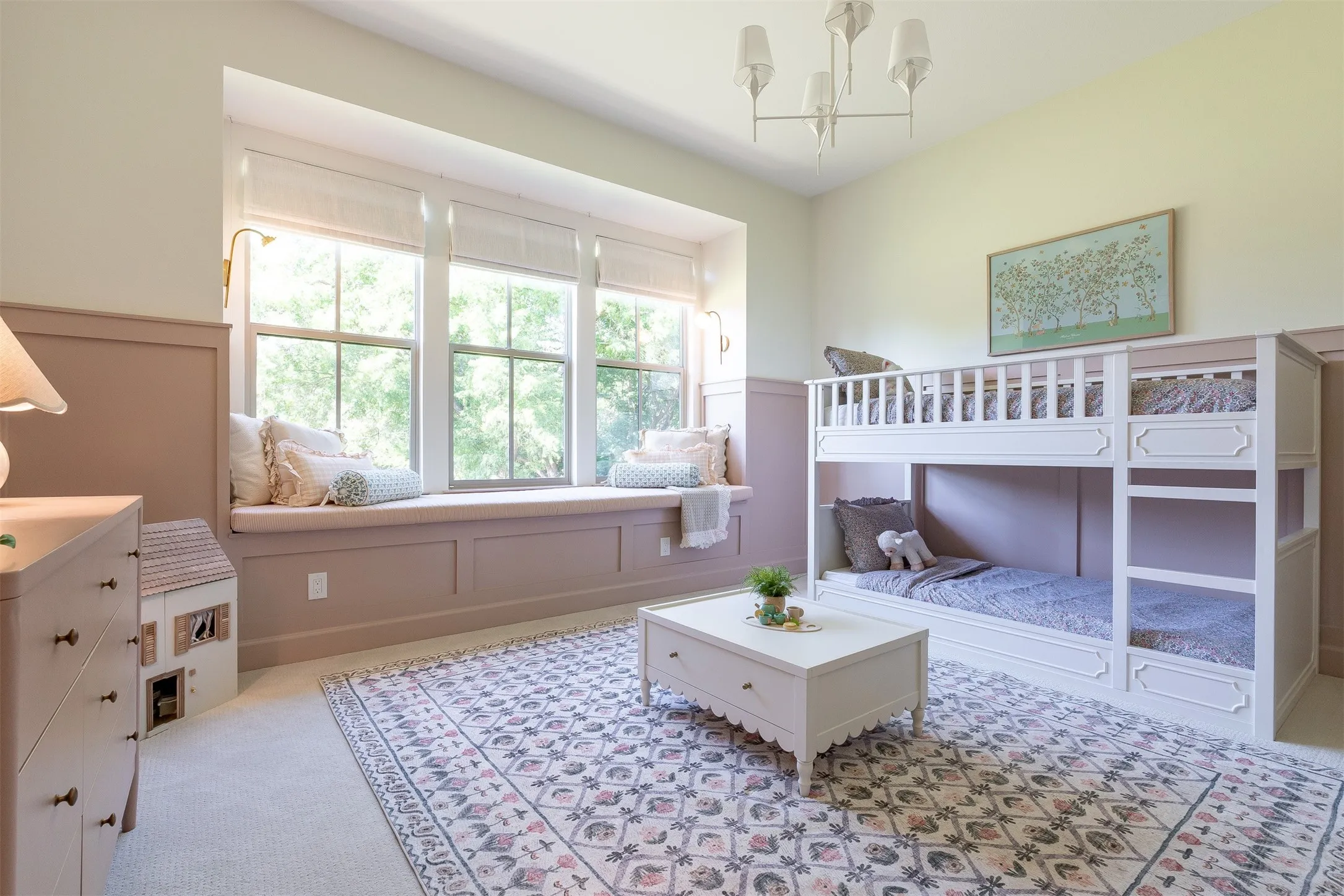 Built-in window seat with storage, wall-mounted sconces, board and batten wall detailing, vaulted ceiling, and recessed lighting