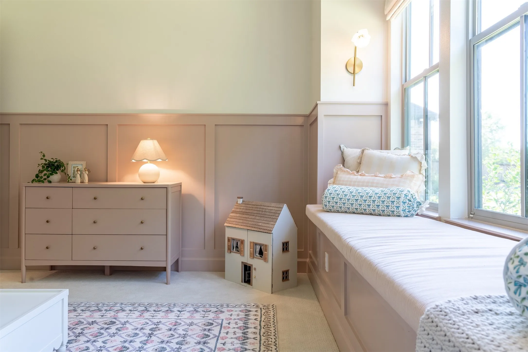 Board and batten wall detailing, built-in window seating, and a wall-mounted sconce