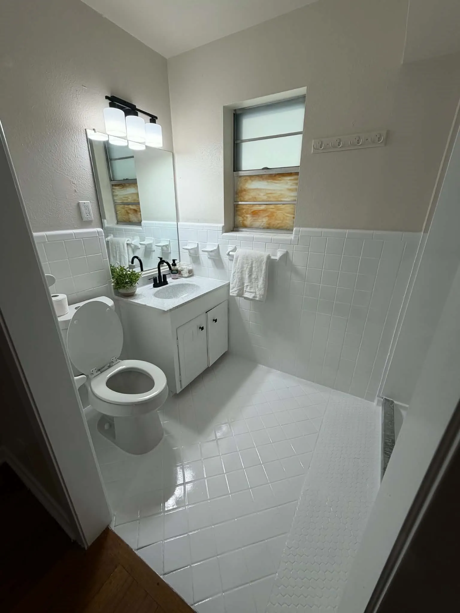 White tiled flooring and wainscoting