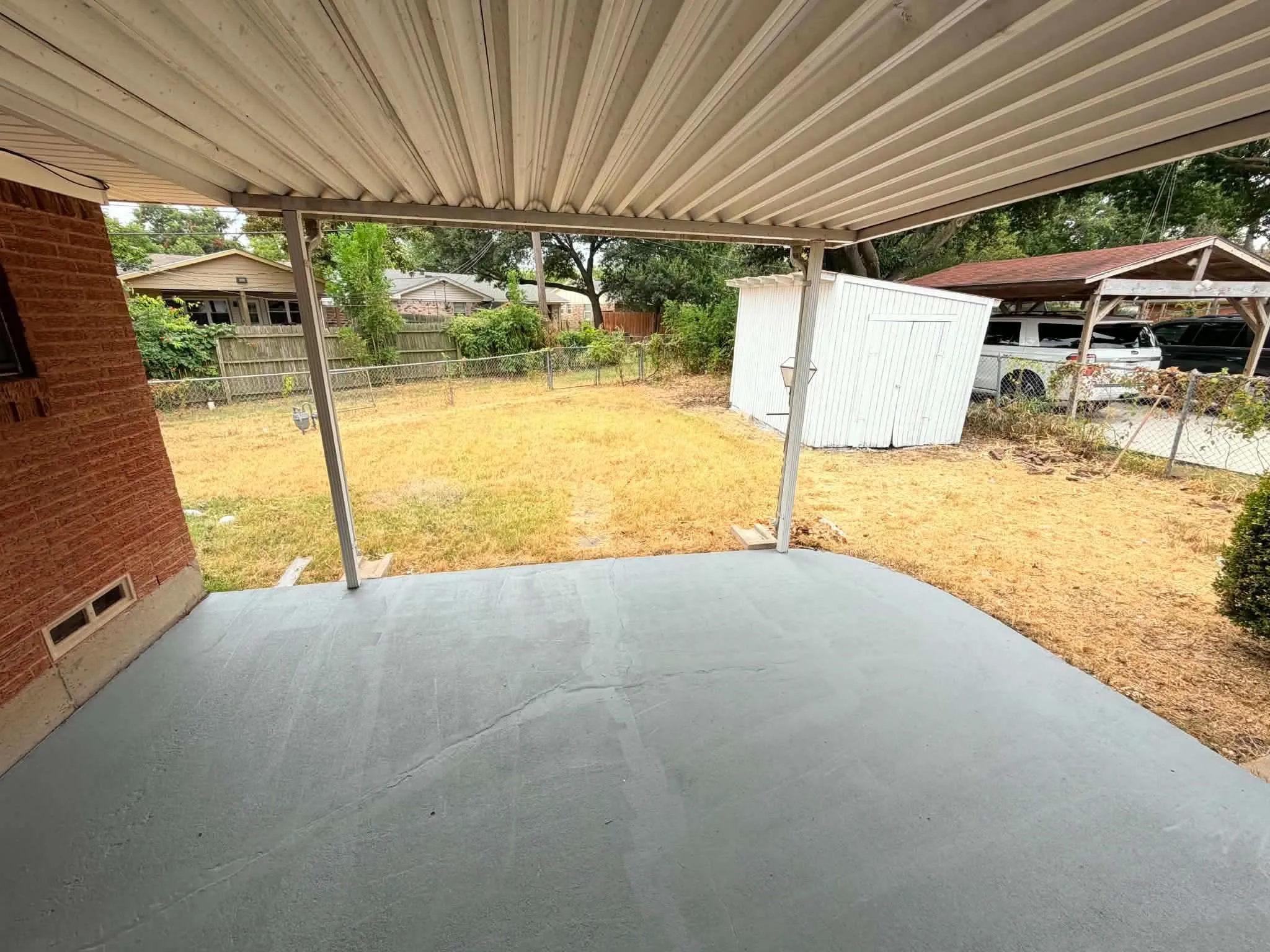 Covered patio with a painted concrete surface