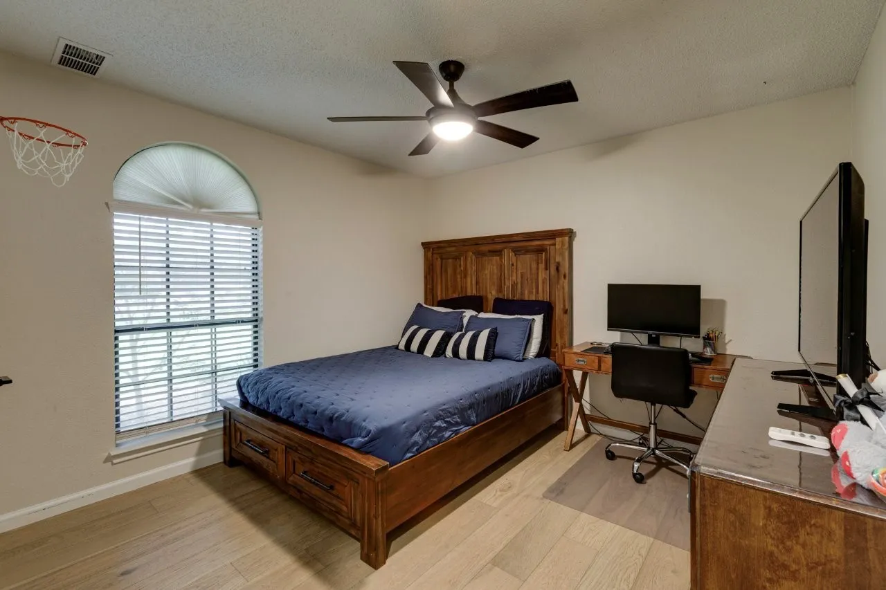 Recessed lighting, wood-finish flooring, ceiling fan, arched window, and window blinds