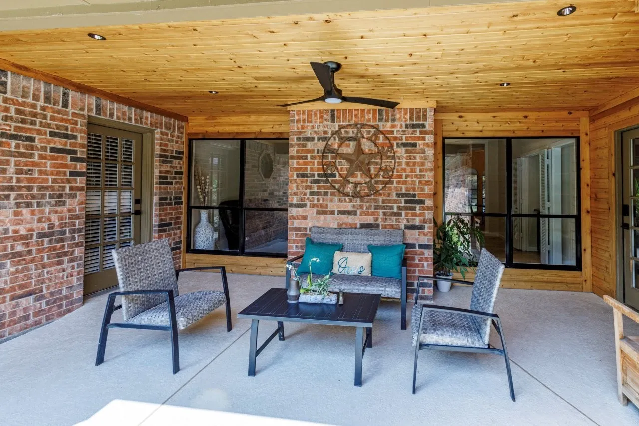 Covered patio featuring brick masonry, wood-paneled ceiling, recessed lighting, and a ceiling fan