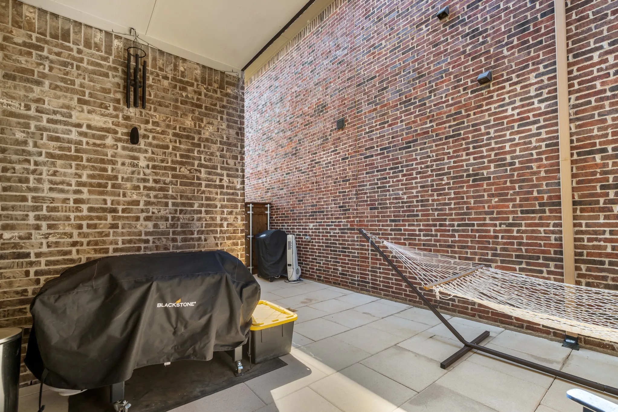 Private Patio with stone and turf, no maintenace required