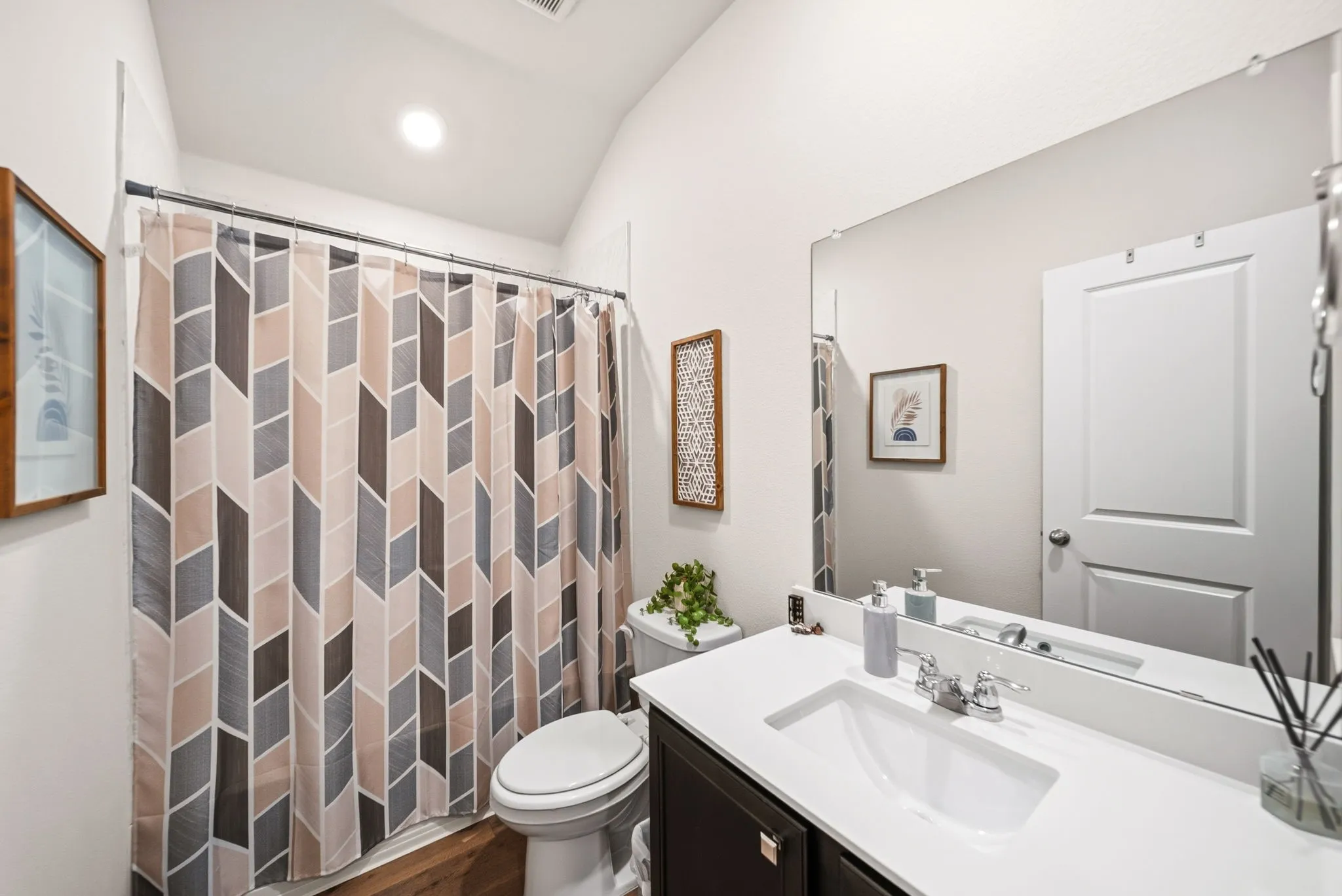 Vanity with an integrated rectangular sink, chrome faucet, and dark wood-finish cabinetry