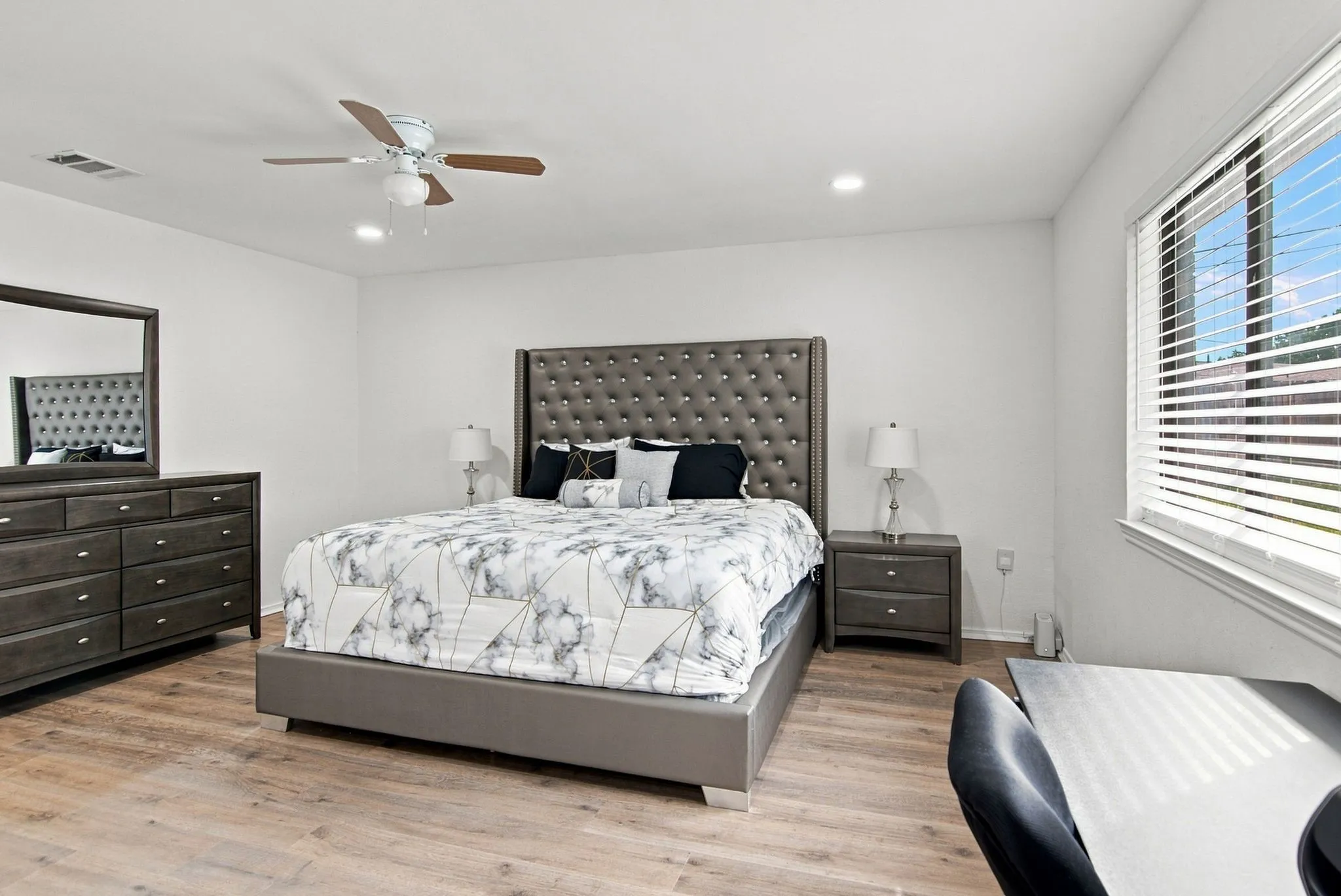Recessed lighting, wood-finish flooring, ceiling fan, and window with blinds