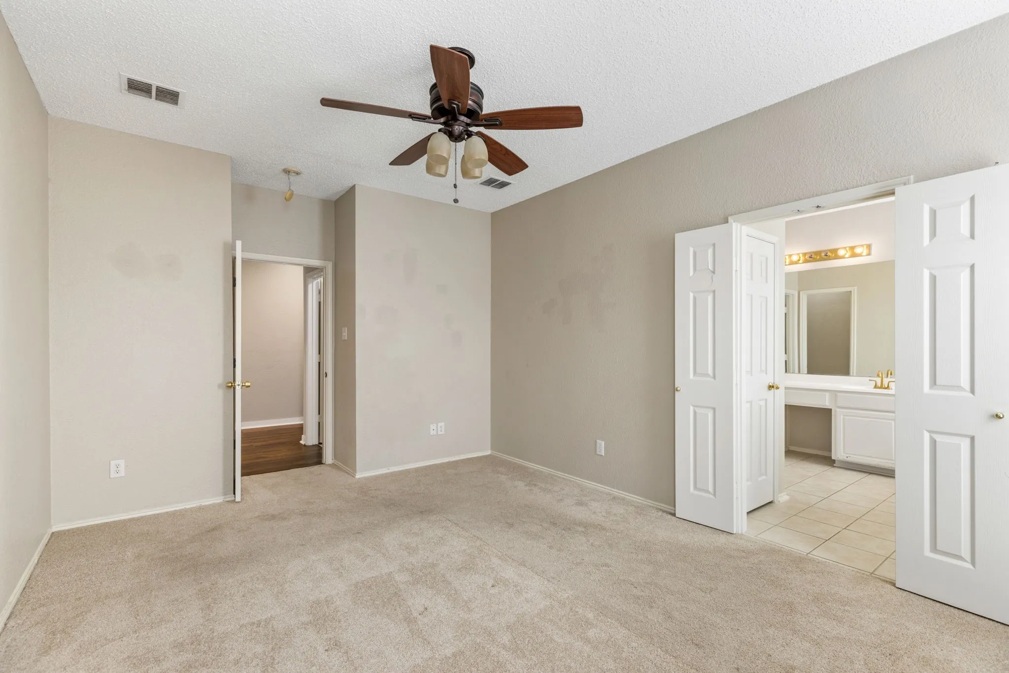 Neutral-toned walls complement carpeted flooring