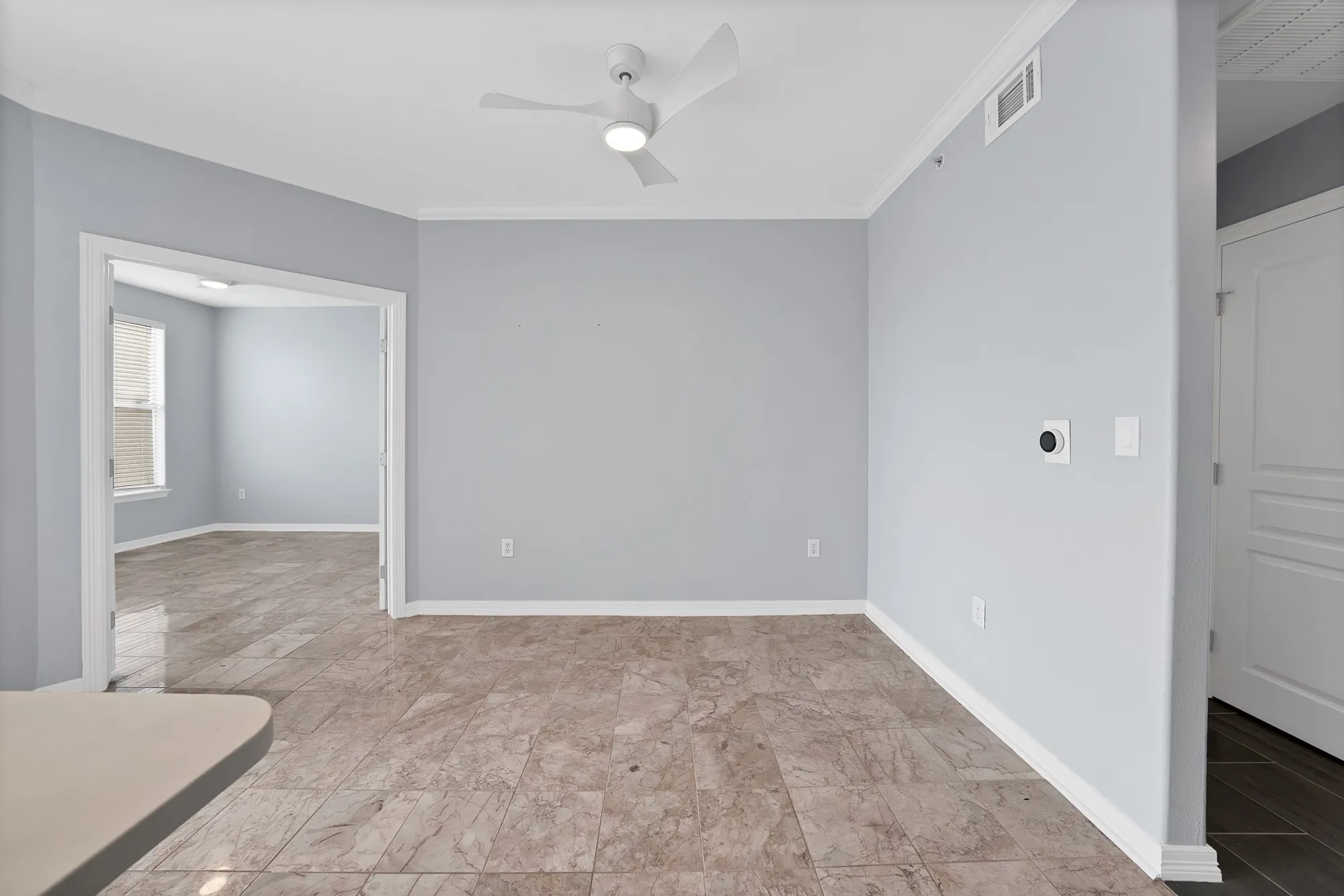 Recessed lighting, crown molding, ceiling fan, tile flooring, and white trim throughout