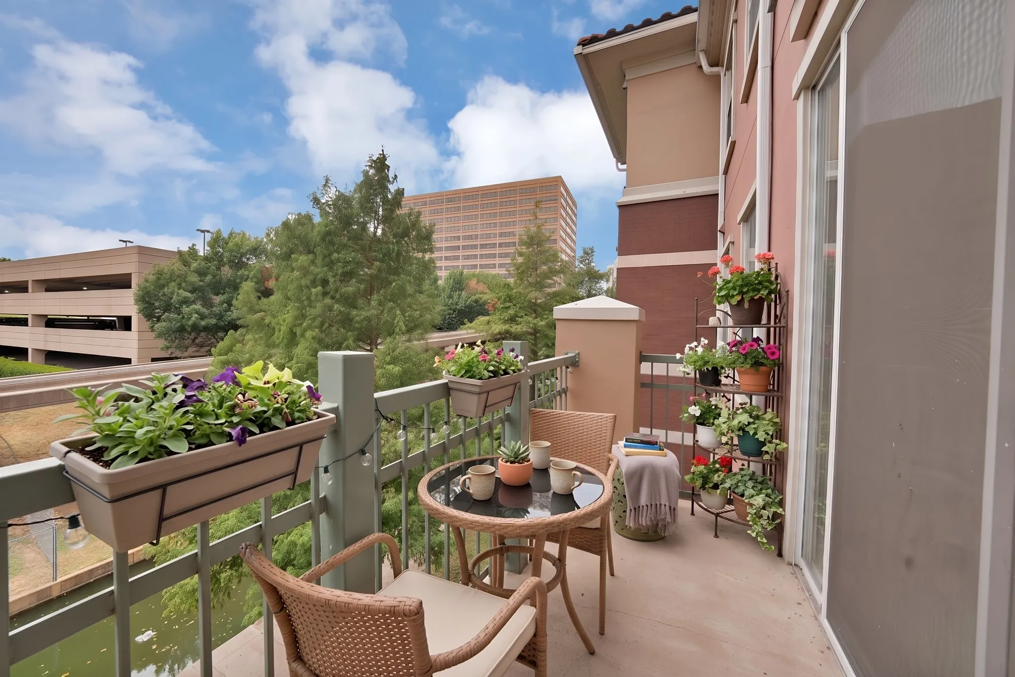 Balcony featuring a sliding glass door, metal railing, and stucco exterior walls