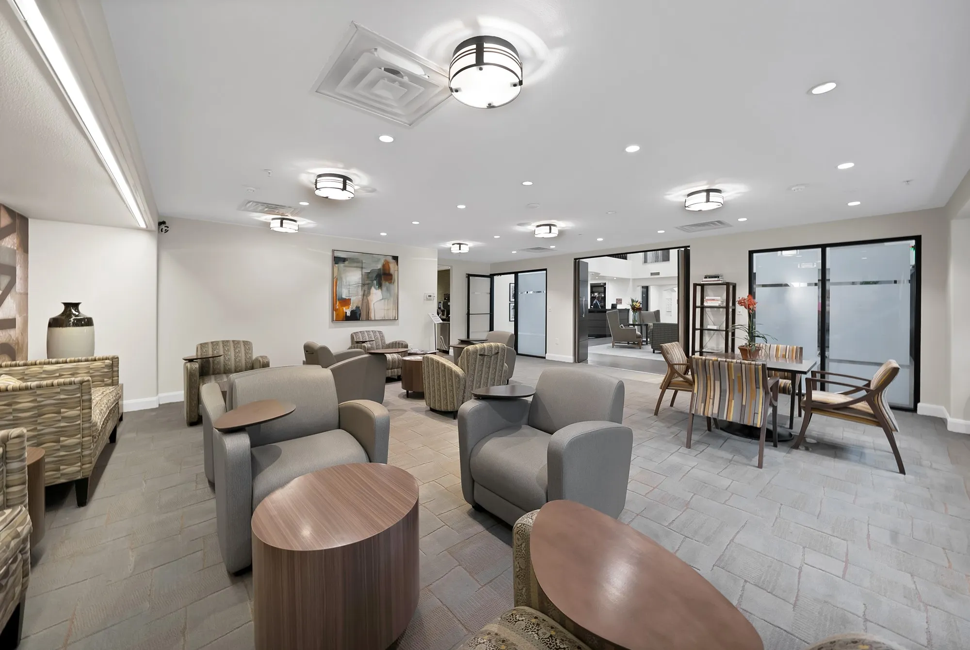 Spacious interior with recessed lighting, ceiling-mounted lighting fixtures, and light-toned flooring