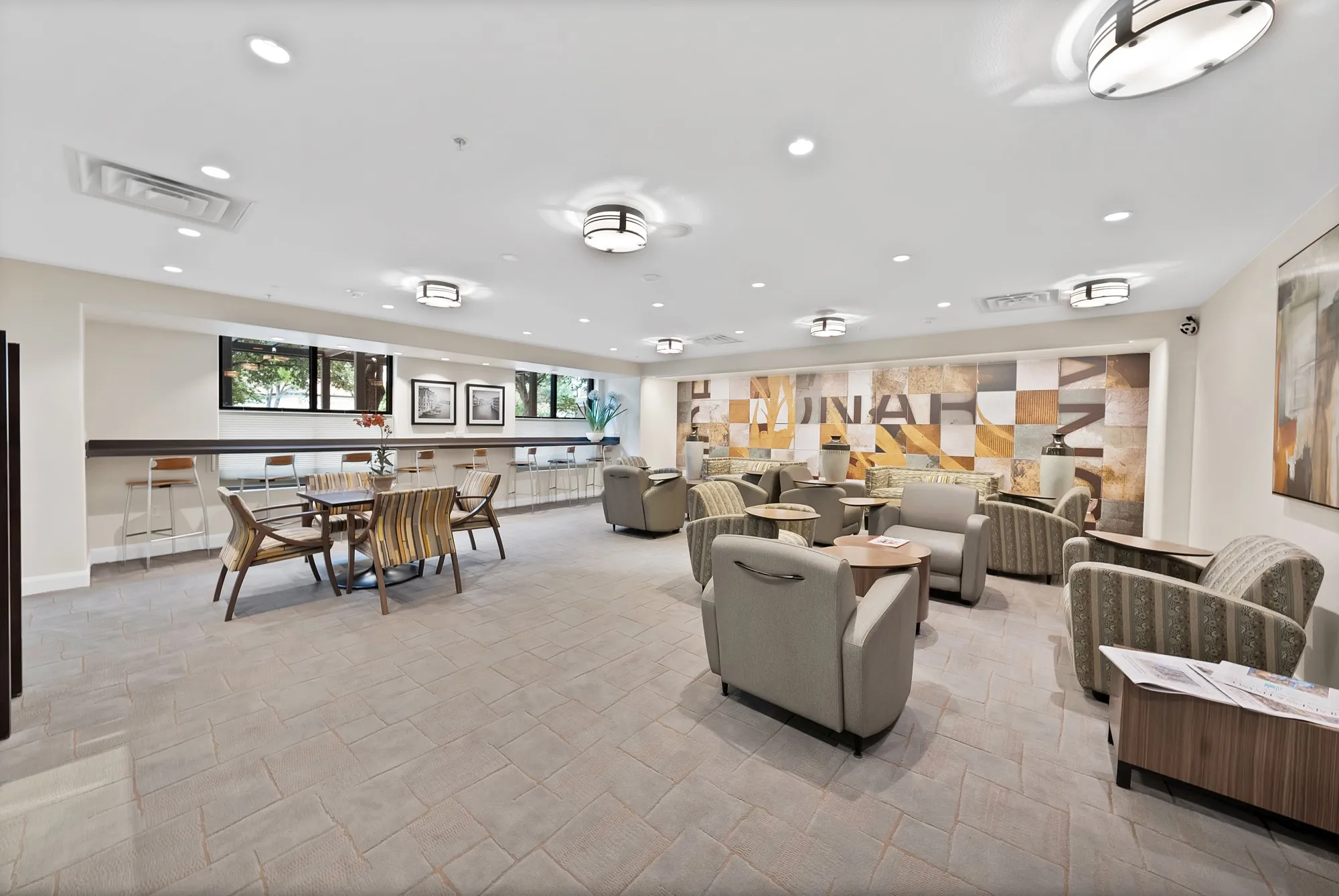 Spacious common area featuring recessed lighting, ceiling-mounted fixtures, and a decorative accent wall