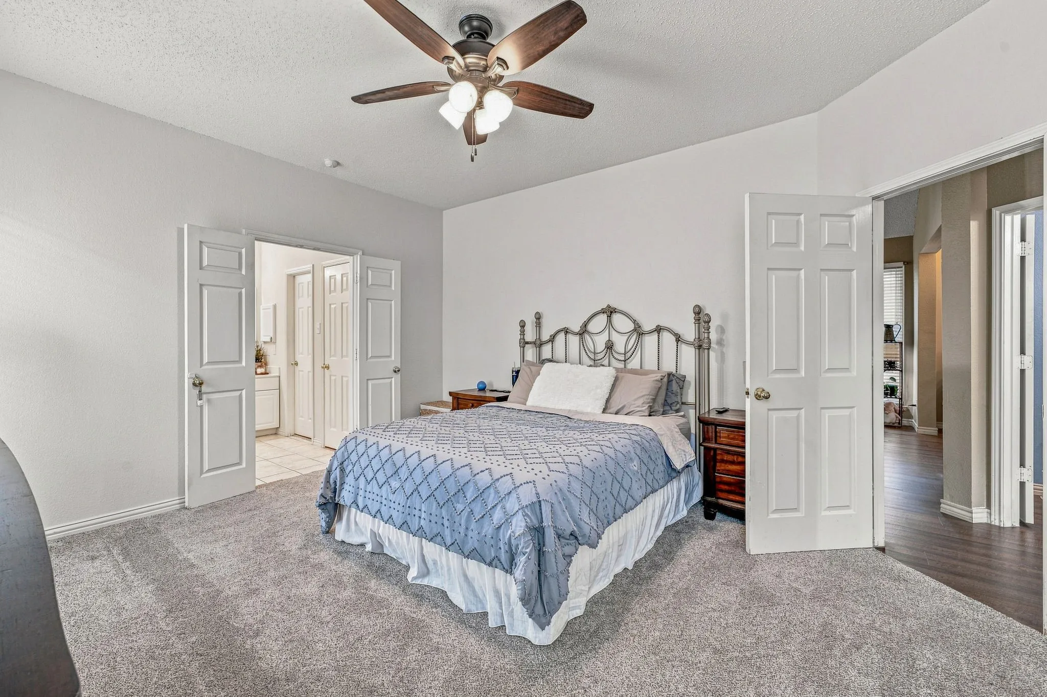 Carpeted flooring, vaulted ceiling, and a ceiling fan with integrated lighting