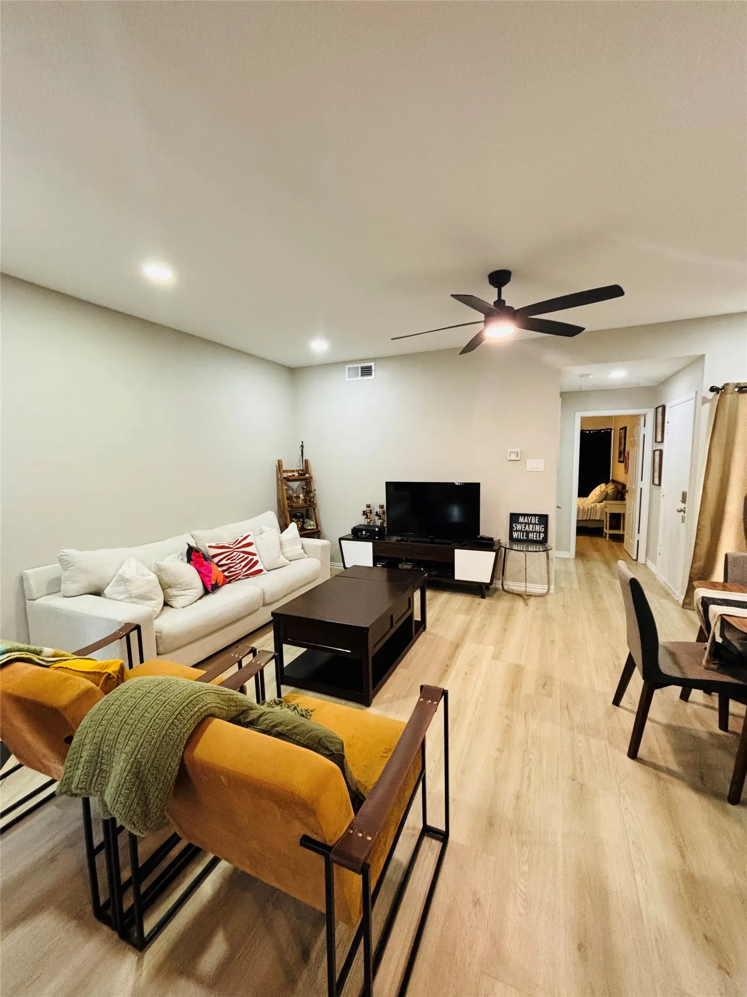 Recessed lighting, wood-finish flooring, and a ceiling fan