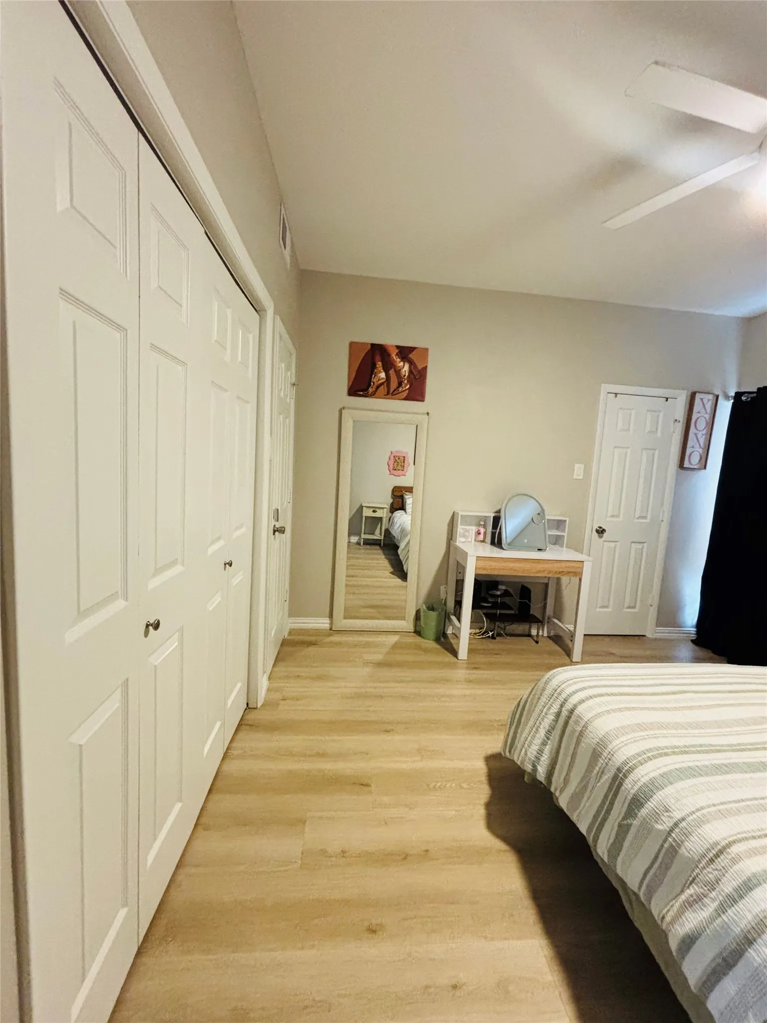 Wood-finish flooring throughout, complemented by white bi-fold closet doors