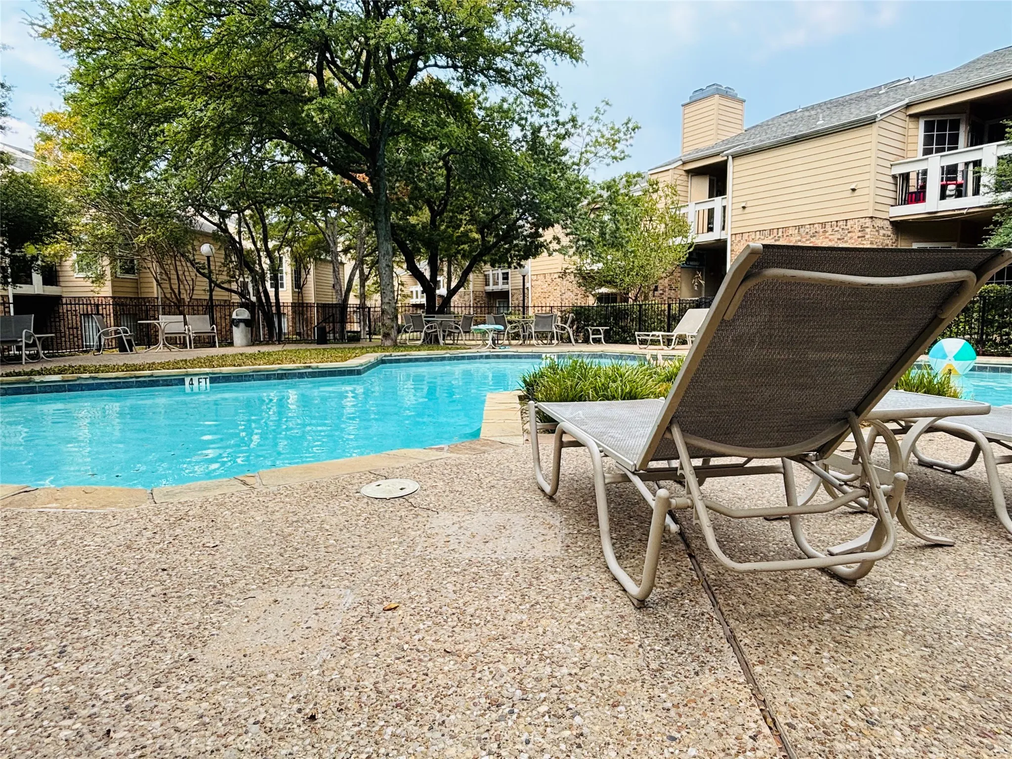 Resort-style pool with a concrete surround and ample lounge areas