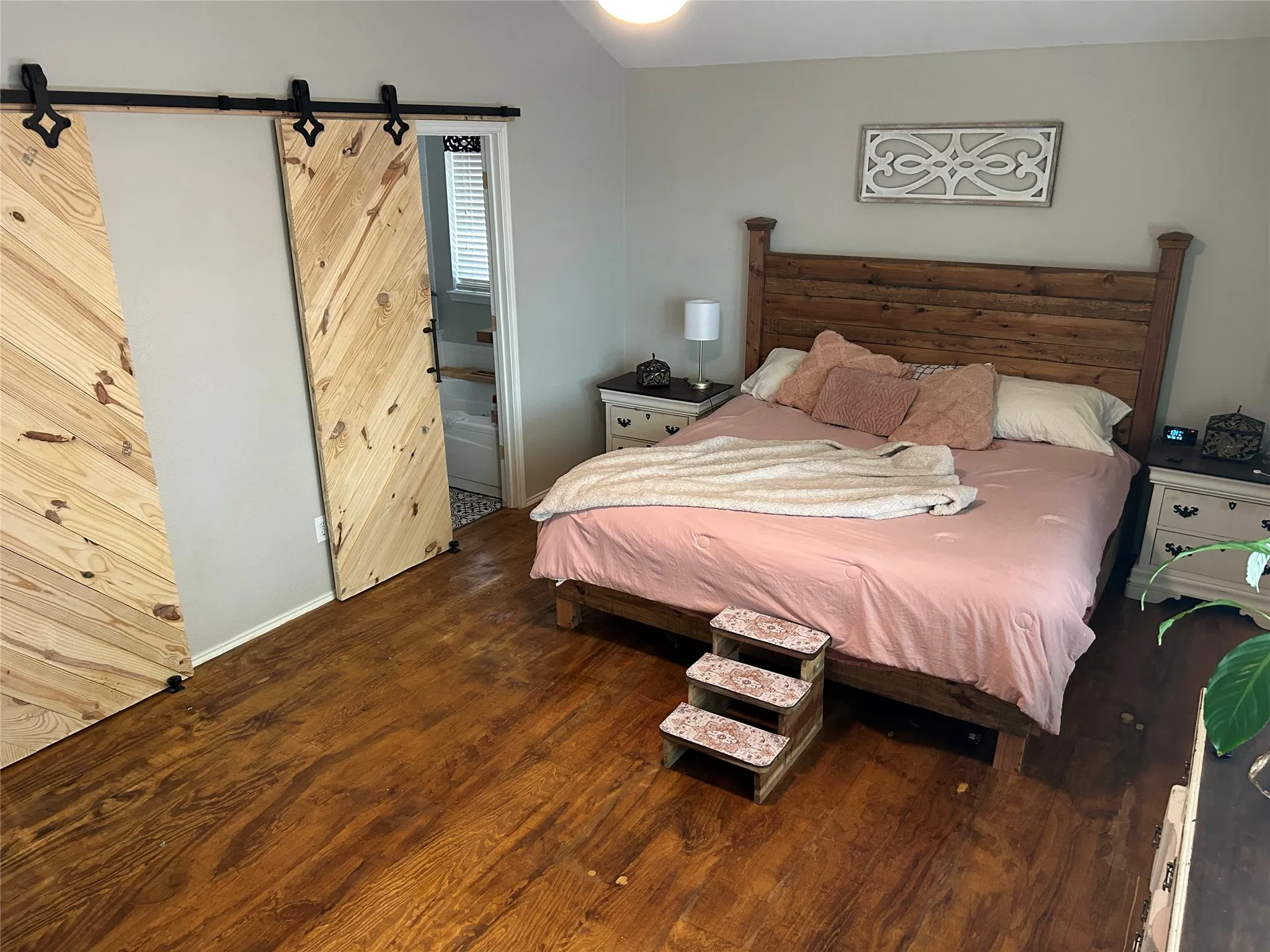 Wood-finish flooring throughout, complemented by light gray wall paint