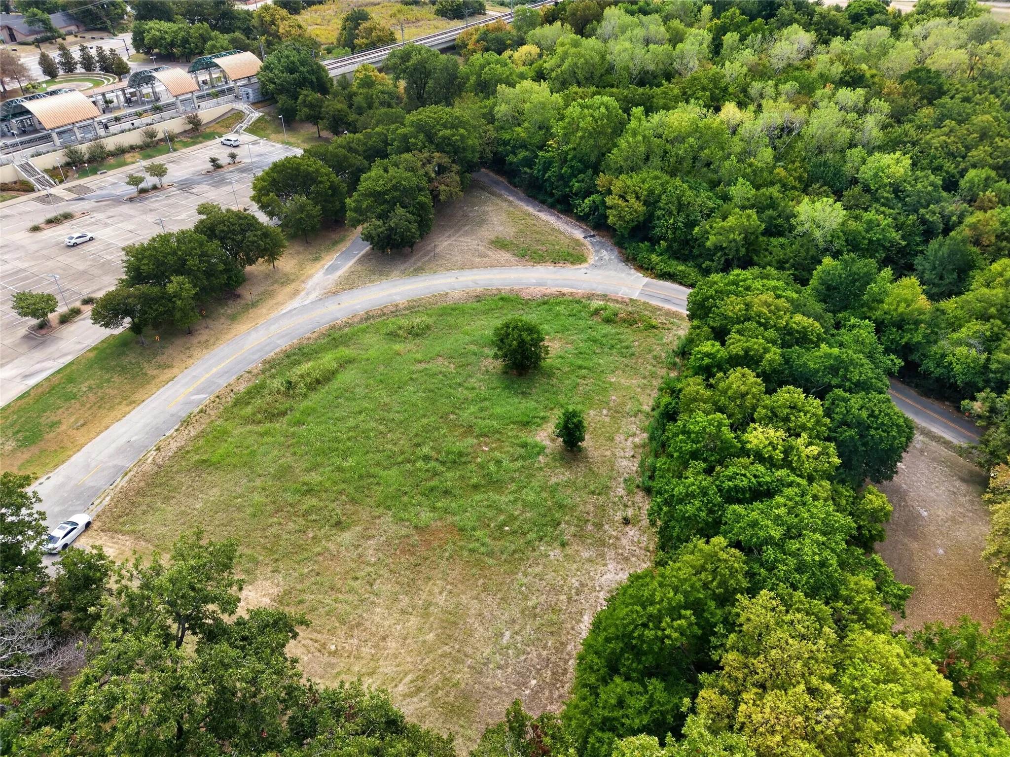 Expansive land parcel with abundant mature trees and verdant green spaces
