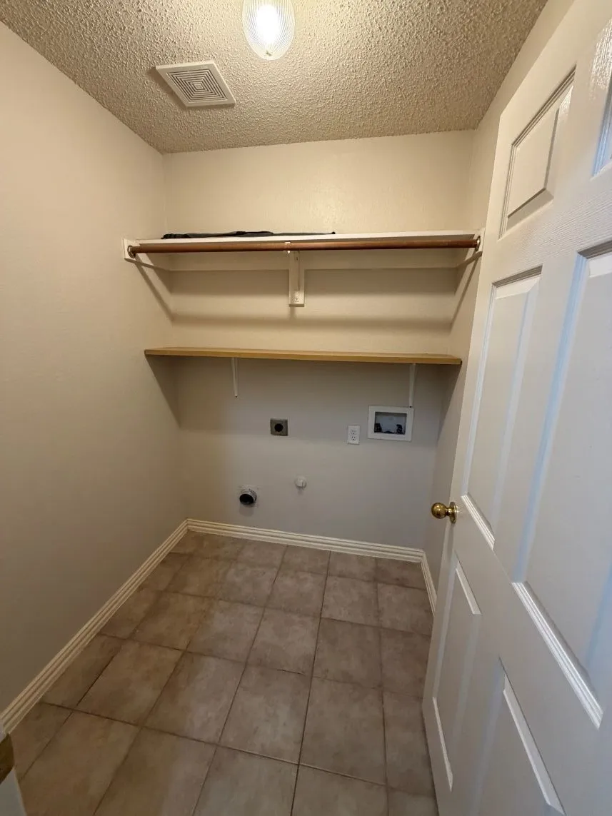 Tile flooring, built-in shelving, clothing rod, panel door