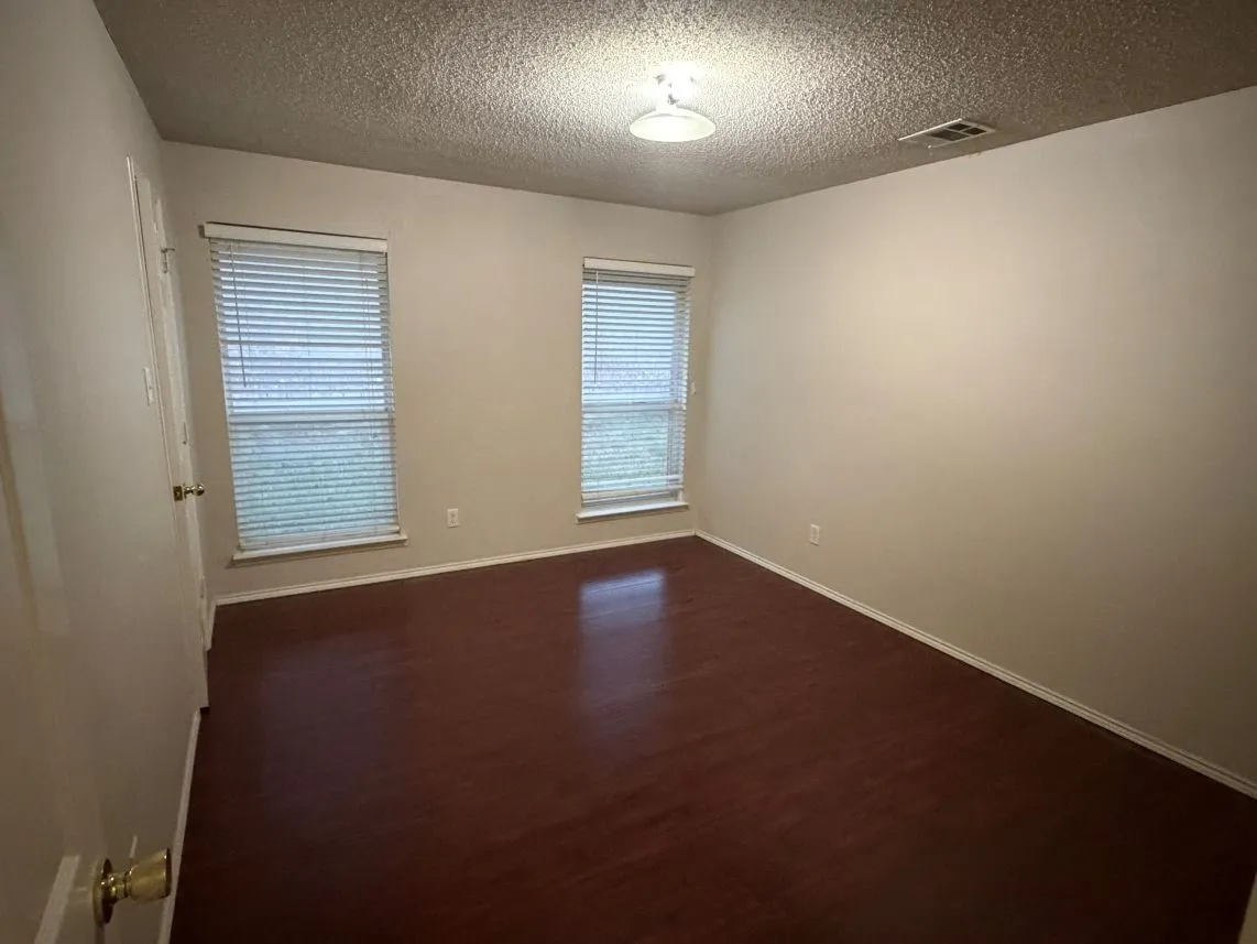 Dark wood-finish flooring with light-colored walls