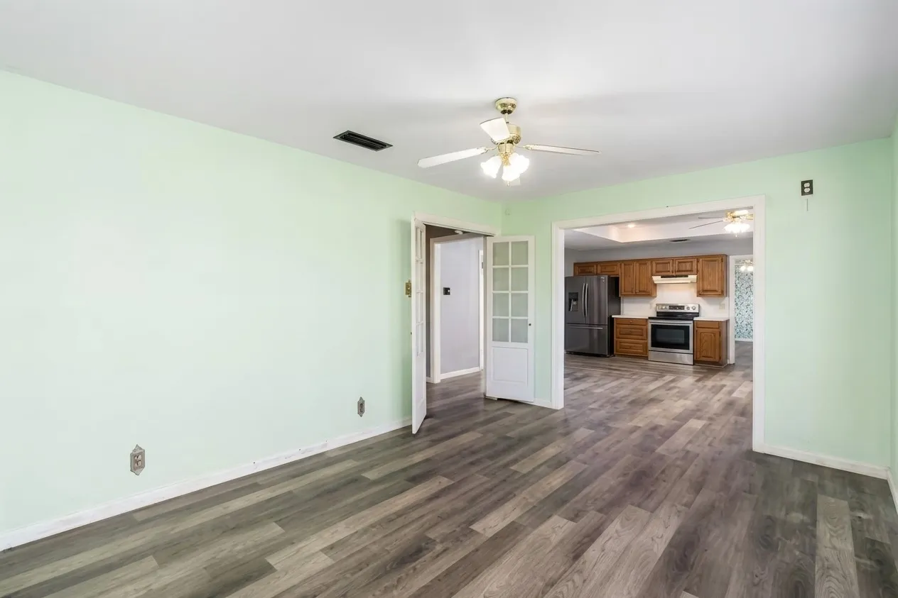 Wood-finish flooring throughout, with a ceiling fan