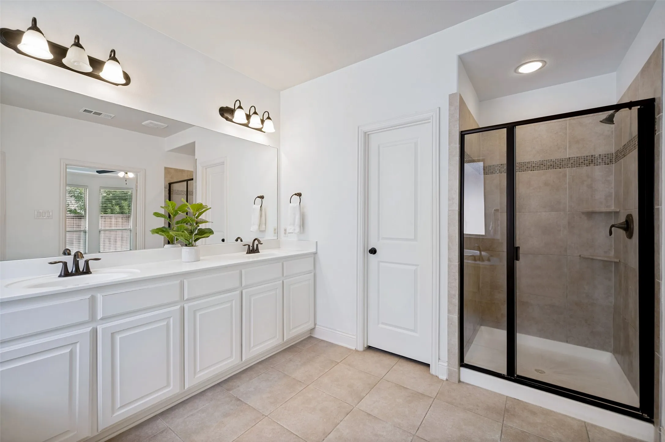 Separate shower view in the primary bathroom
