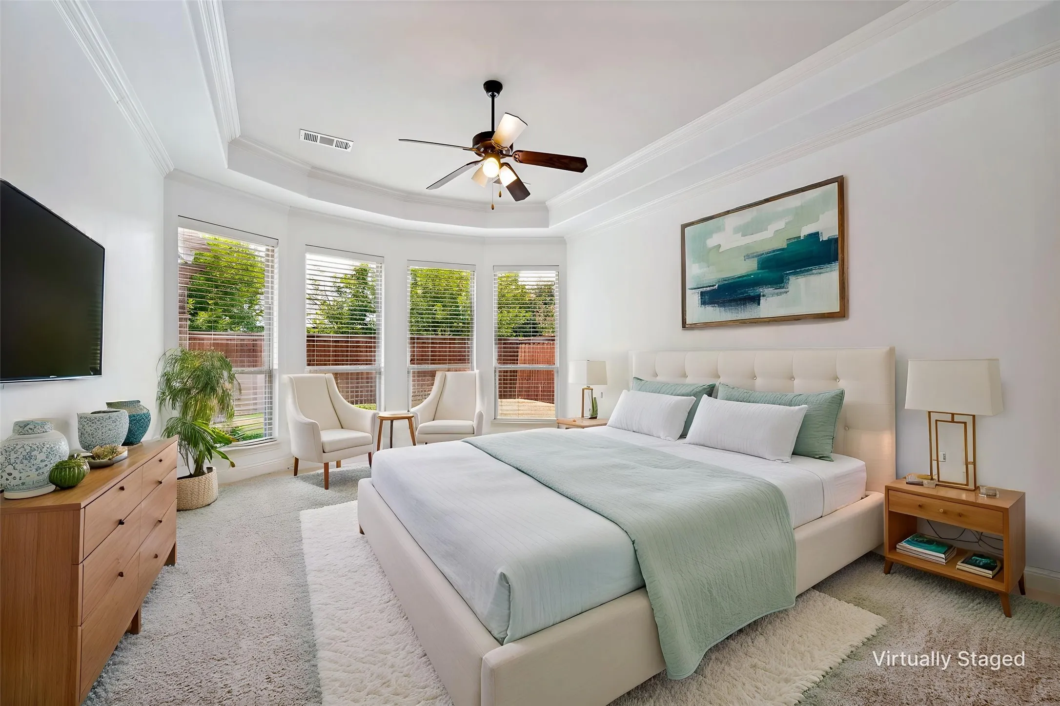 Elegant primary bedroom with a wall of windows