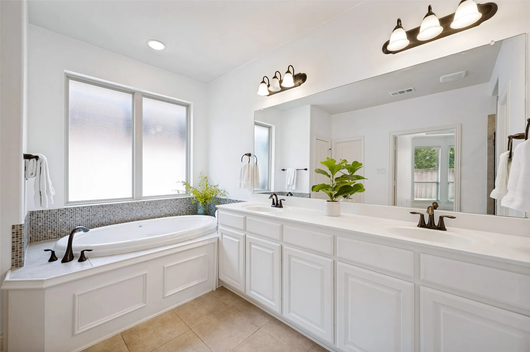 Garden tub and dual vanities in the primary bath