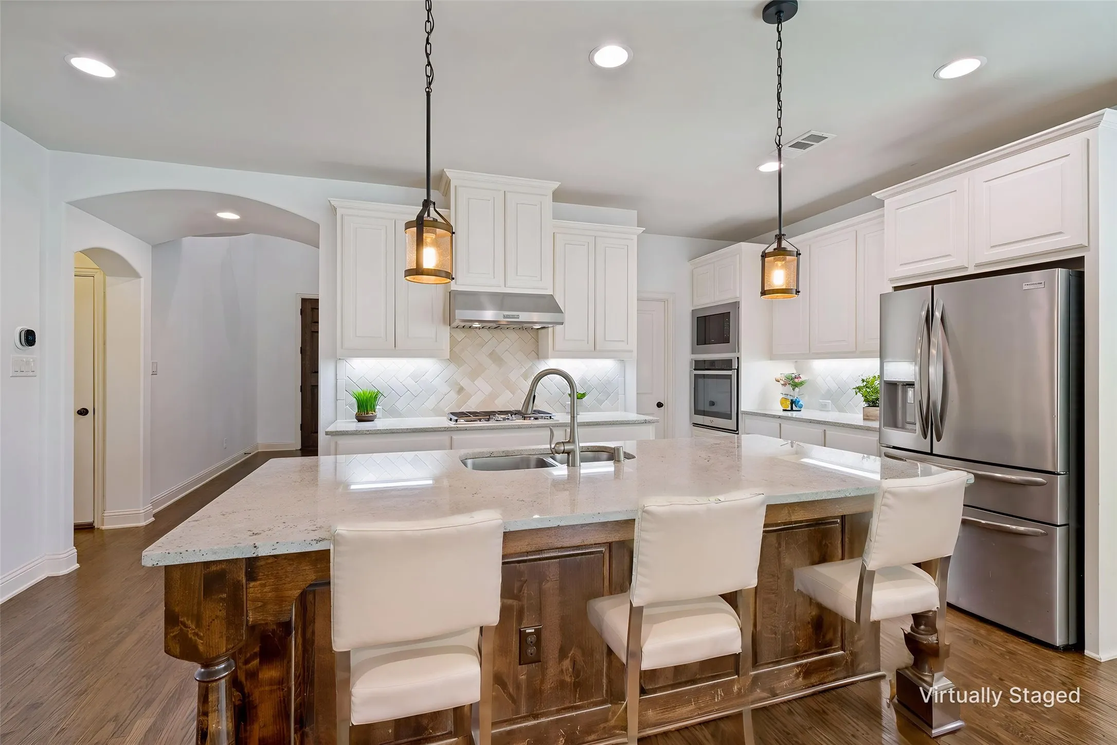 Expansive kitchen island with pendant lights above