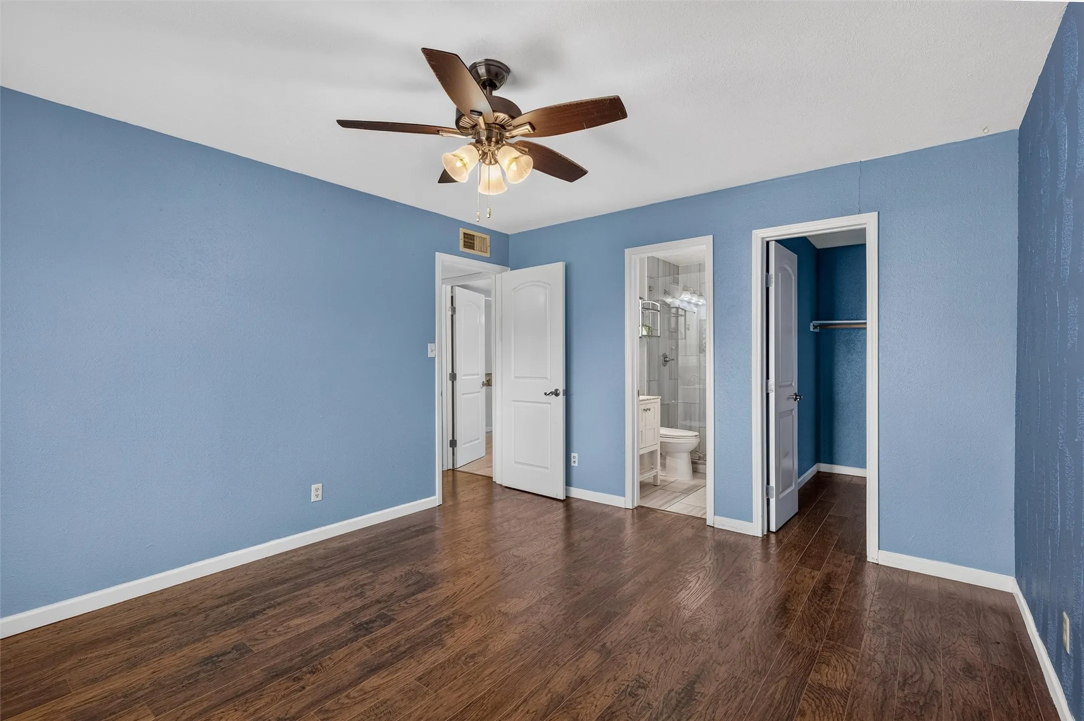 Wood-finish flooring with a ceiling fan light fixture