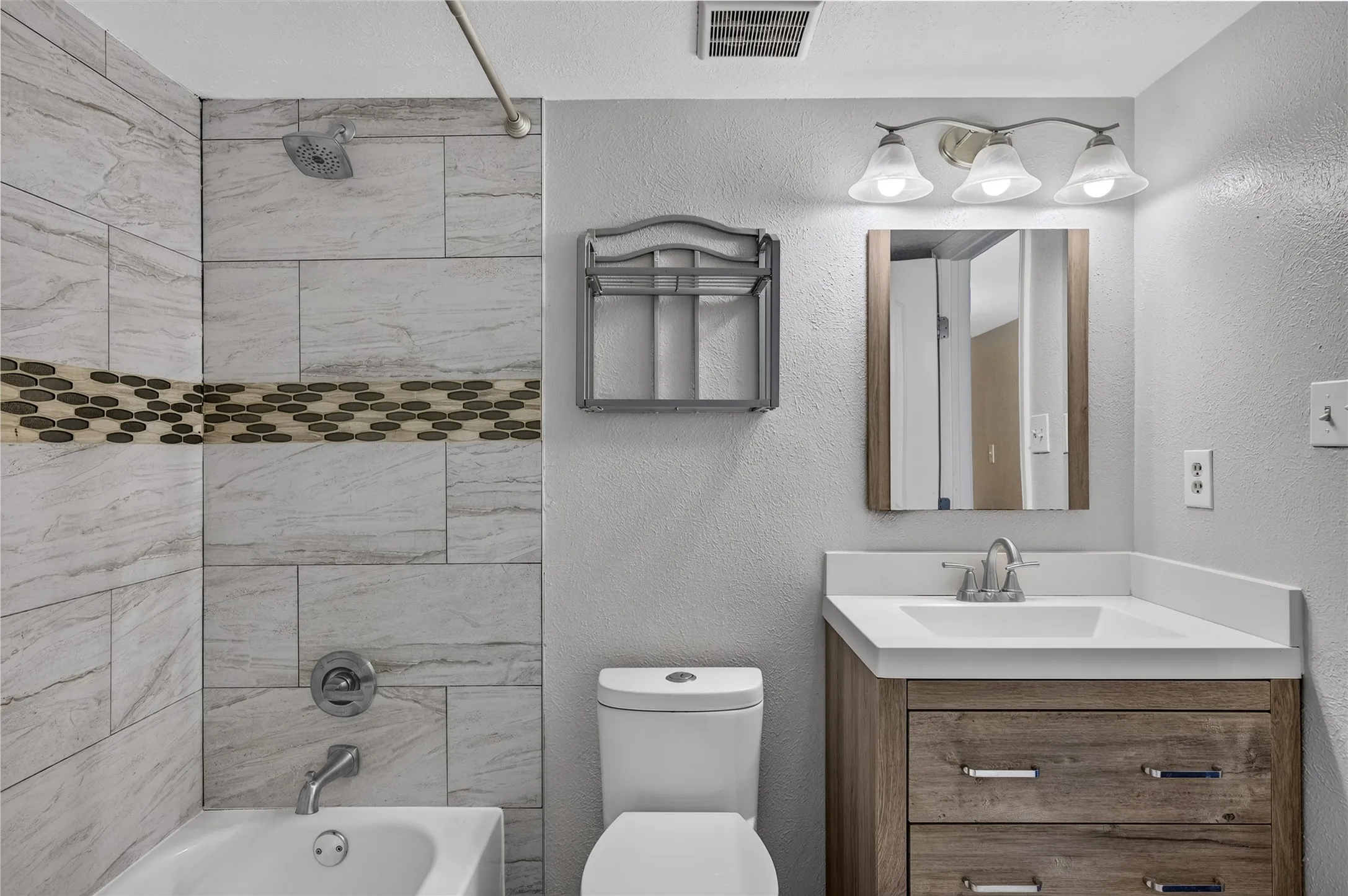 Tub/shower combination with tile surround and mosaic accent