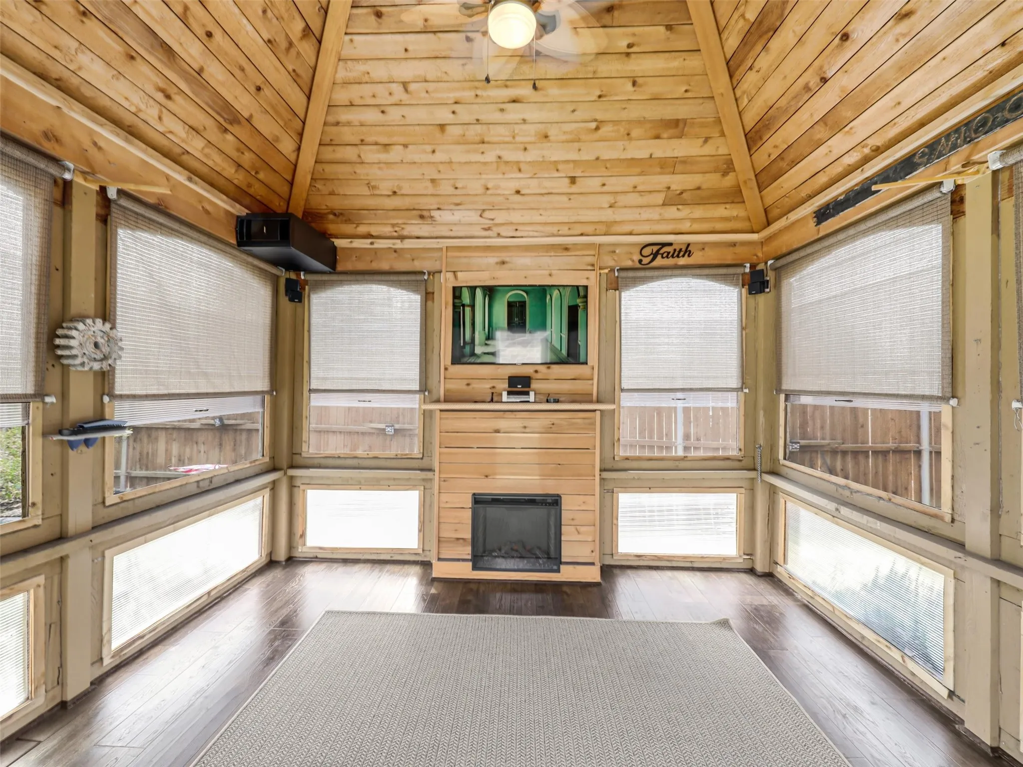BONUS SPACE!!! Enclosed outdoor retreat features warm wood finishes, abundant screened windows, a vaulted ceiling, fireplace, television, and surround-sound speakers.