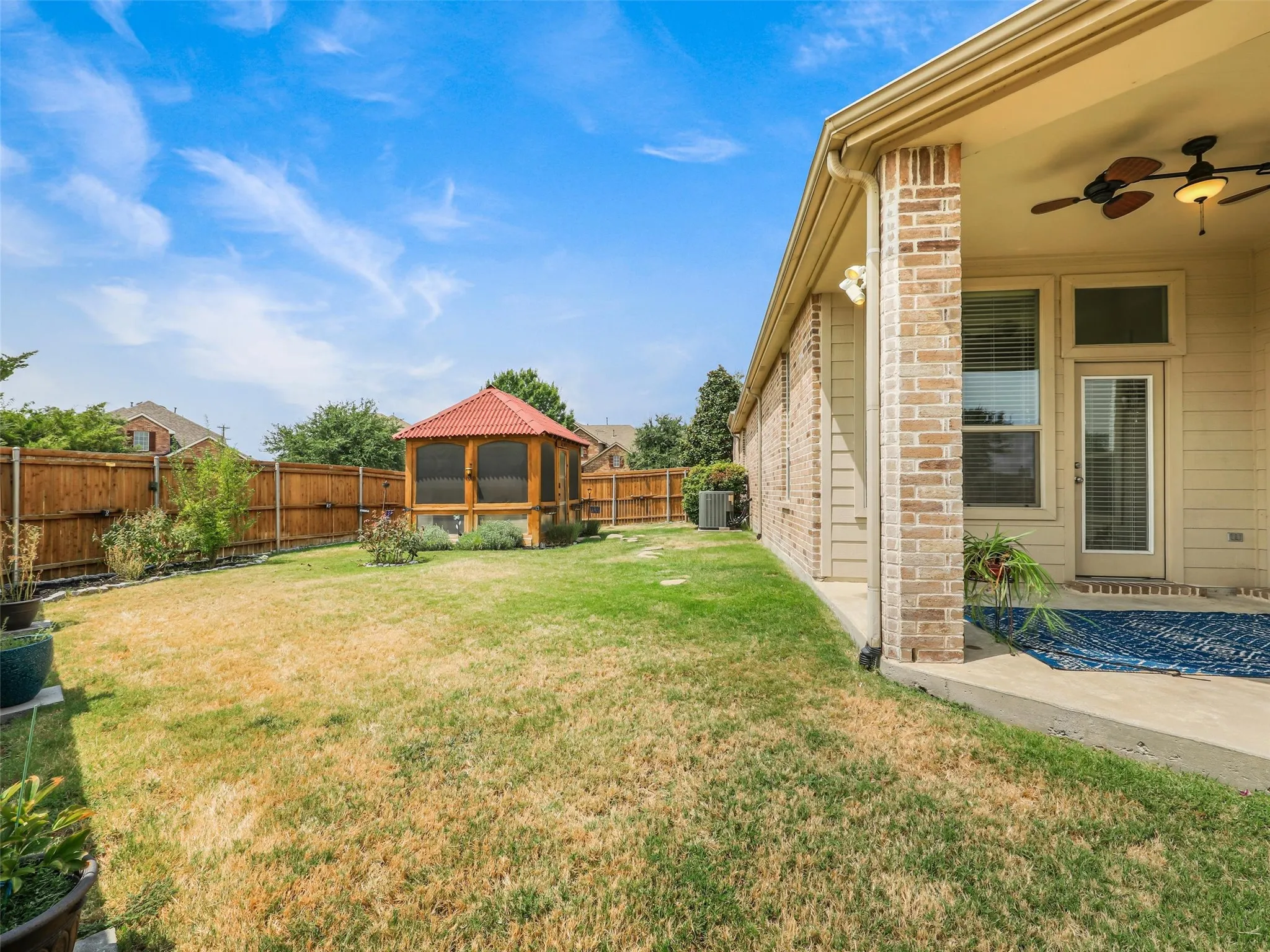 Generous private backyard offers plenty of room to play, garden, or entertain, plus a covered patio and separate screened structure.