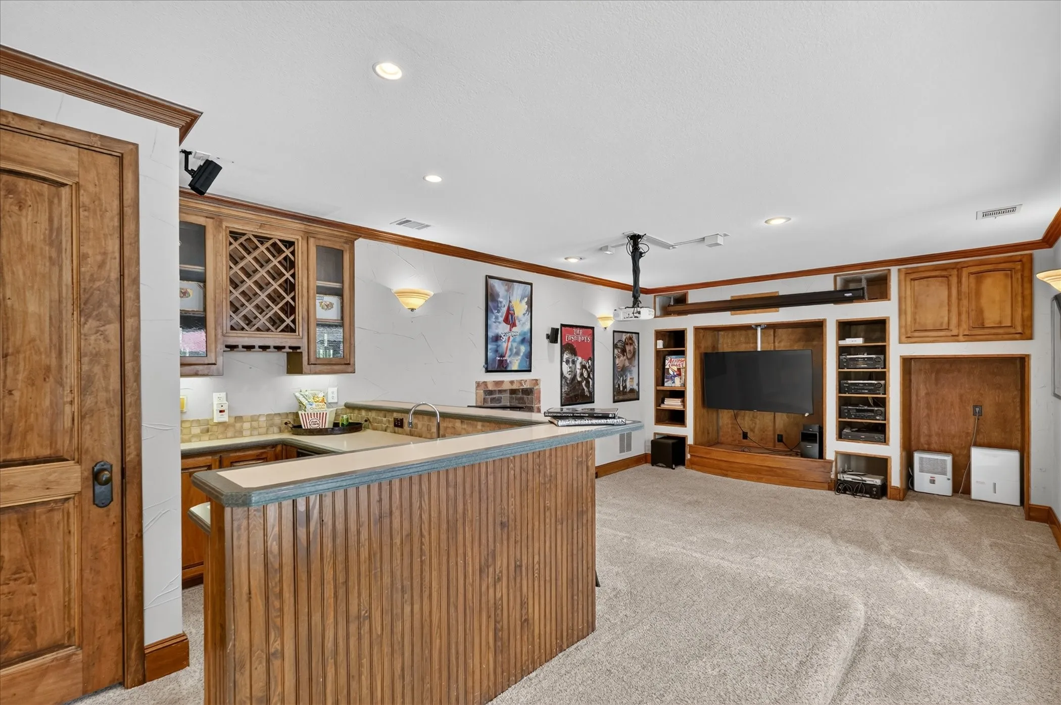 Downstairs, the full walk-out basement creates a private oasis for multi-generational living or guests, highlighting a game room with a wet bar and mini fridge, plus double doors opening straight to the backyard.
